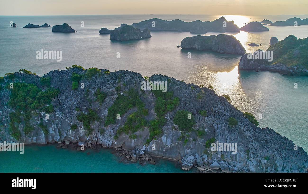 Tramonto nella baia di ha Long - vista aerea delle isole calcaree e delle rocce nel mare. Foto Stock