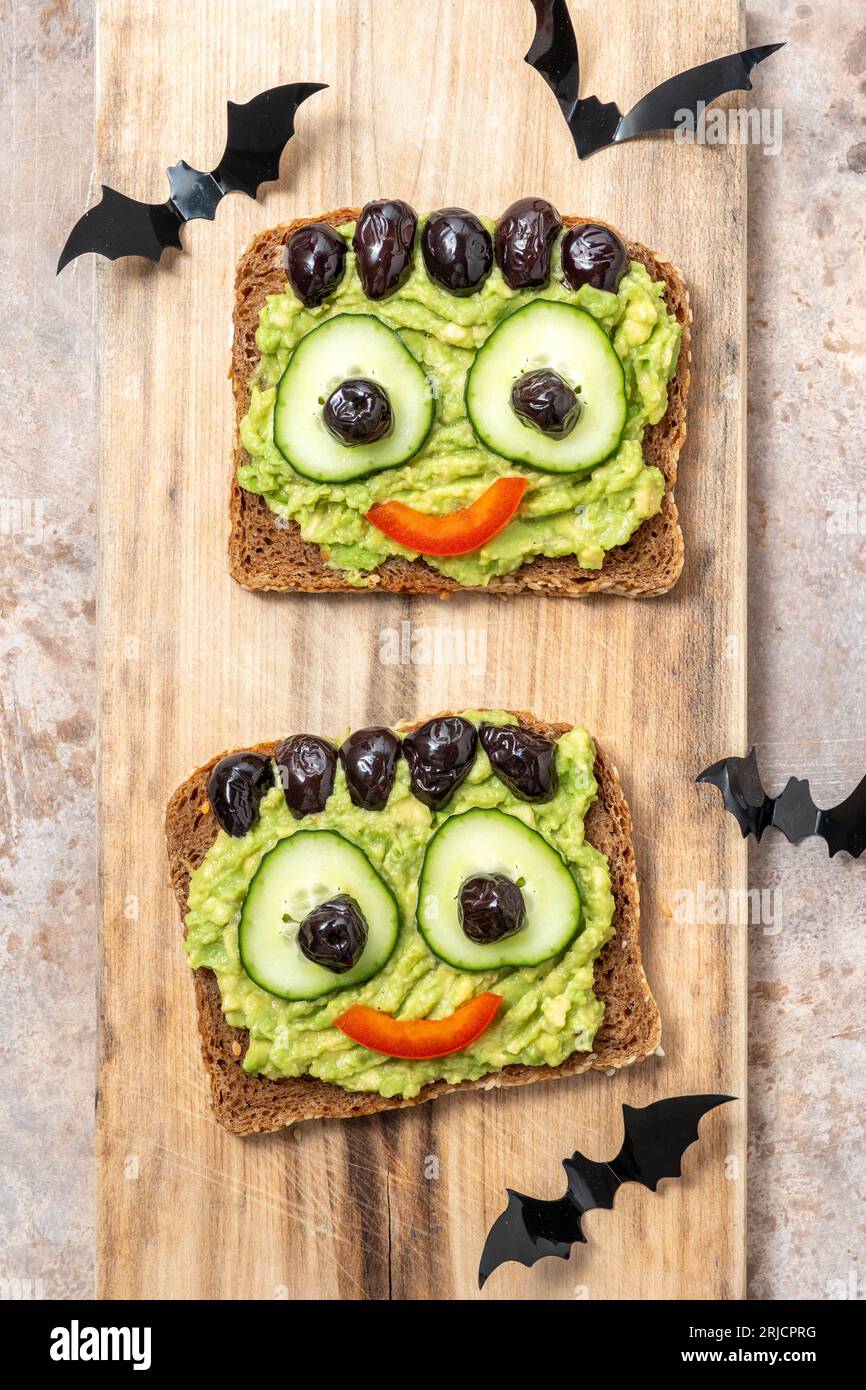 Brindisi con un mostro verde di avocado per Halloween Foto Stock