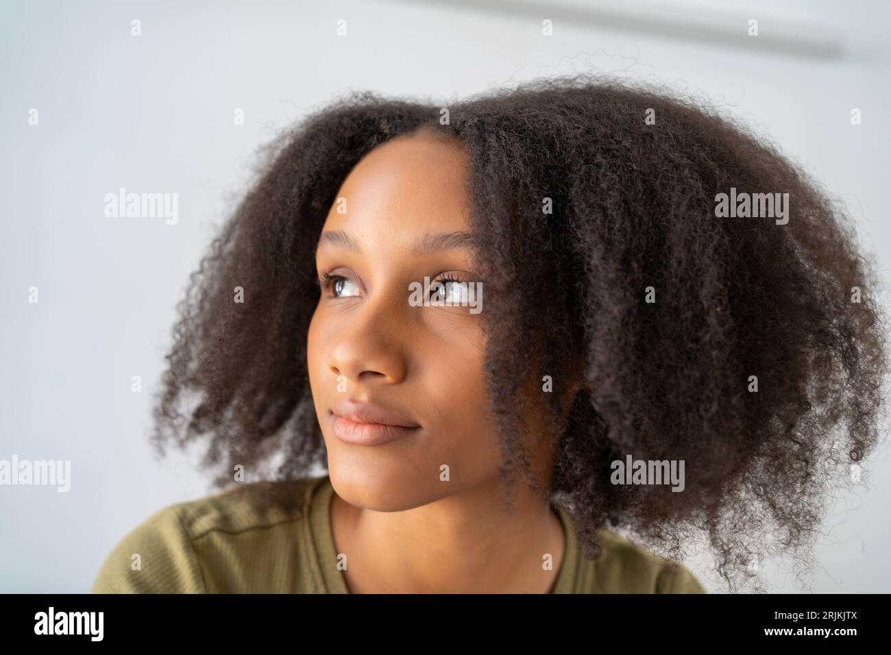 Ragazza afroamericana adolescente con acconciatura afro, graziosa giovane donna ritratto ravvicinato Foto Stock