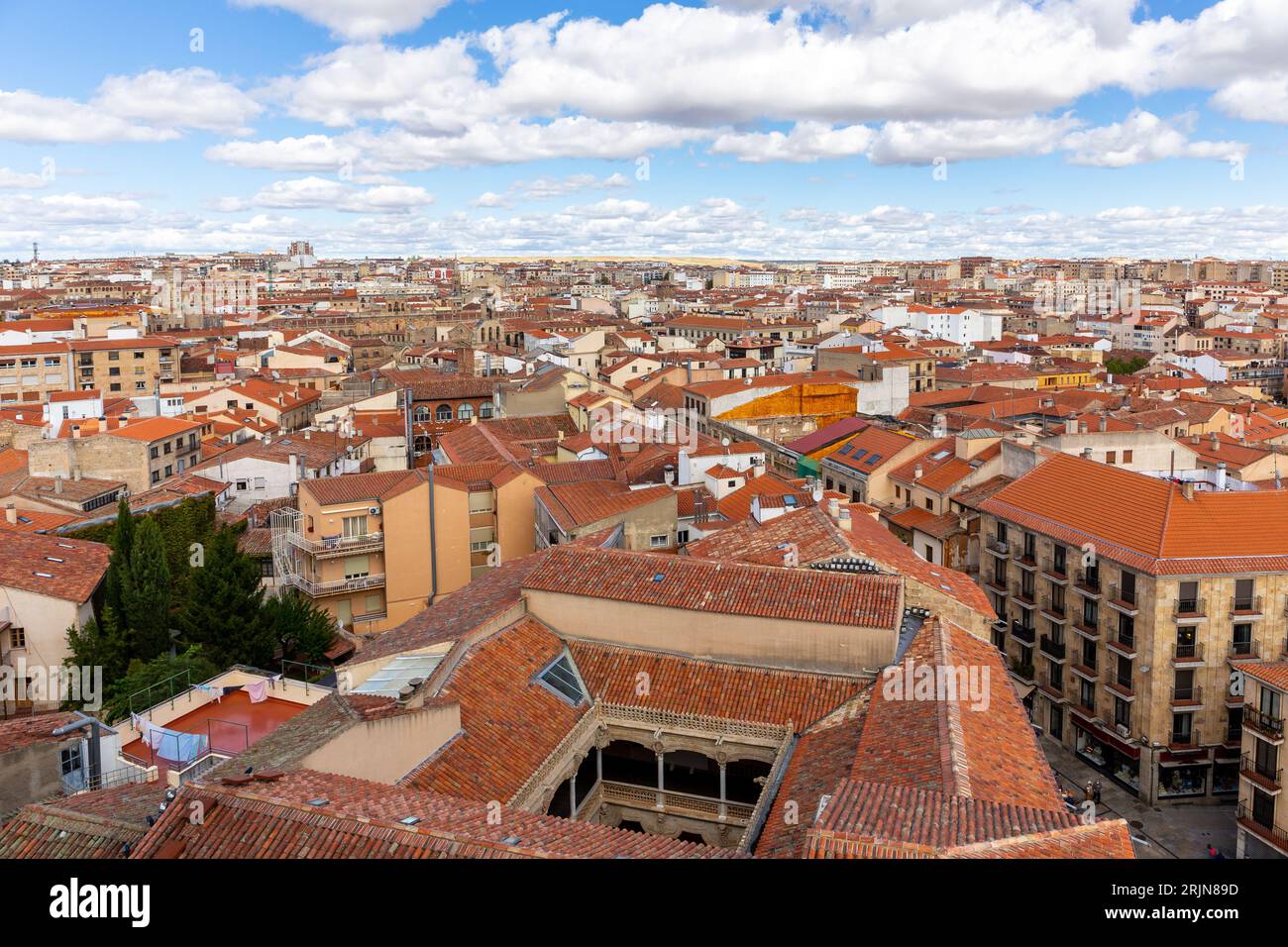 Skyline di Salamanca con cortile Casa de las Conchas, architettura medievale spagnola, tetti in piastrelle arancioni, strade, vista dalla torre la Clerecia. Foto Stock