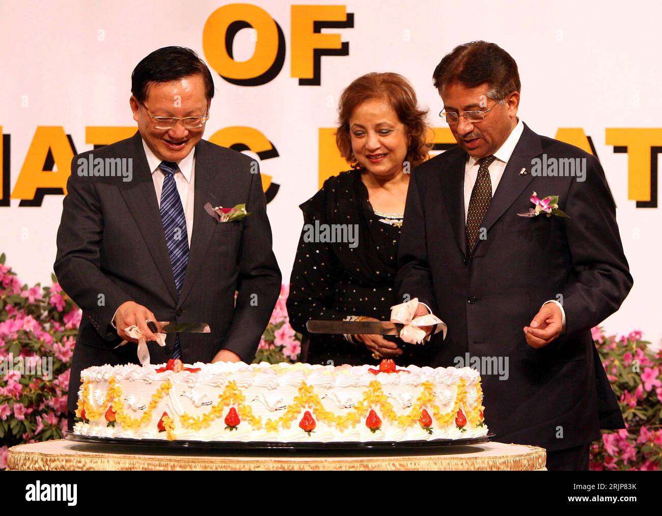 Tang Jiaxuan (li., CHN/Staatssekretär China) und Pervez Musharraf (re., PAK/Staatspräsident Pakistan) mit seiner Ehefrau schneiden ein torte an anlässlich eines Empfangs zum 55. Jahrestag der Aufnahme chinesisch-pakistanischer diplomatischer Beziehungen a Pechino - PUBLICATIONxNOTxINxCHN Foto Stock