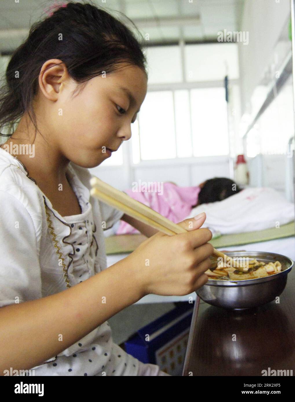 Bildnummer: 53263900 Datum: 14.08.2009 Copyright: imago/Xinhua (090814) - FENGXIANG(SHAANXI), 14 agosto 2009 (Xinhua) - Una bambina di nove anni di avvelenamento da piombo di nome lei Xinyue ha il suo pranzo al Fengxiang County Hospital, nella provincia dello Shaanxi della Cina nord-occidentale, 14 agosto 2009. Più di 600 bambini che vivono in due villaggi adiacenti a Dongling Lead e Zinc Smelting Co. Hanno mostrato livelli anormali di piombo nel sangue, le autorità locali hanno annunciato martedì, con tutti i 166 bambini di avvelenamento da piombo di livello medio o alto sono stati inviati all'ospedale locale per un trattamento gratuito. (Xinhua/Chen Gang) (ypf) (2)CINA-FENGXIANG-CHI Foto Stock