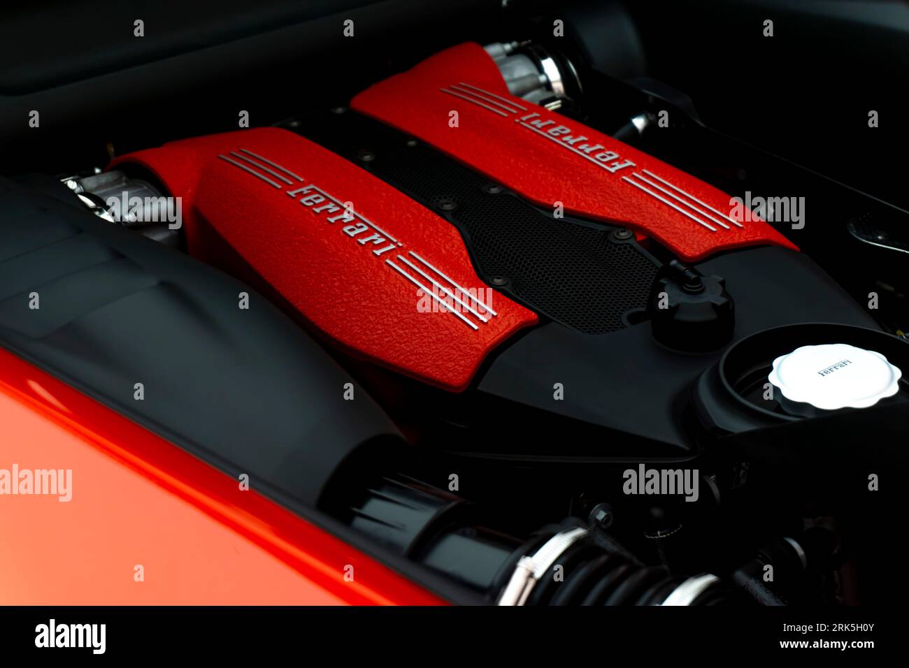A close-up view of the red Ferrari automobile engine inside an open car trunk Foto Stock
