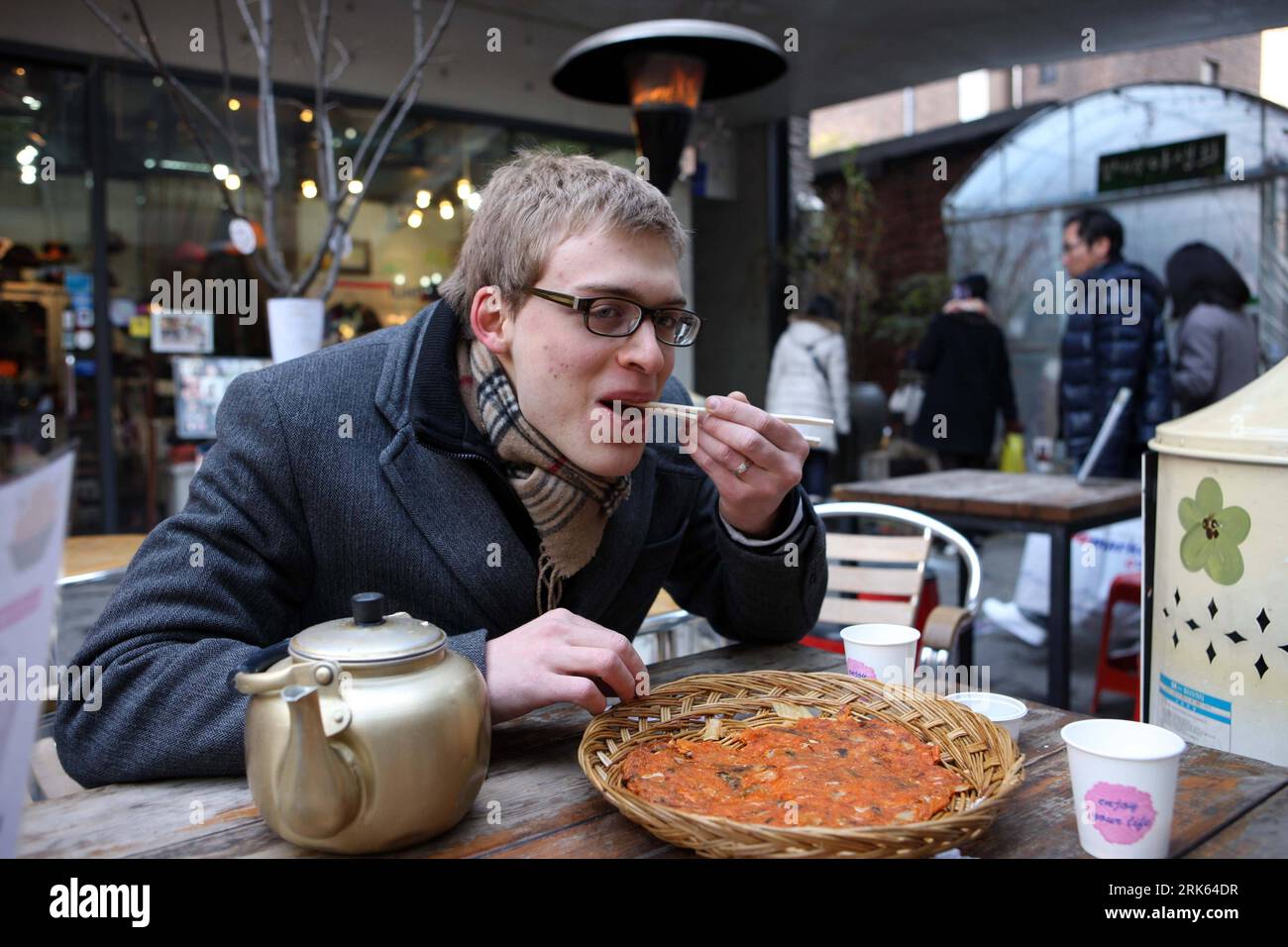 Bildnummer: 53794886 Datum: 13.02.2010 Copyright: imago/Xinhua (100213) - SEOUL, 13 febbraio 2010 (Xinhua) -- Un turista goditi il kimchi pancake coreano a Sadong a Seoul, capitale della Corea del Sud, 13 febbraio 2010. Le attività tradizionali si svolgono a Seul il primo giorno della vacanza del Festival di Primavera, attirando molti turisti.(Xinhua/He Lulu) (msq) (3)COREA DEL SUD-FESTIVAL DI PRIMAVERA PUBLICATIONxNOTxINxCHN Festival kbdig xcb 2010 quer o0 Frühlingsfest, Neujahr, Essen, Südkorea Bildnummer 53794886 Data 13 02 2010 Copyright Imago XINHUA Seoul Feb 13 2010 XINHUA un turista Godetevi il Kimchi Pancake Coreano PRESSO Foto Stock