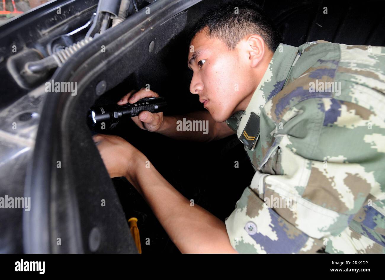Bildnummer: 54178198 Datum: 24.06.2010 Copyright: imago/Xinhua (100626) -- DEHONG(YUNNAN), 26 giugno 2010 (Xinhua) -- Un soldato di un posto di blocco ispeziona un veicolo per droghe illegali nascoste durante un'operazione antidroga nella prefettura autonoma di Dehong, nel sud-ovest della Cina, provincia dello Yunnan, 24 giugno 2010. Il checkpoint di Dehong è stato fondato nel 1978 e si trova vicino al Myanmar e all'area del Triangolo d'Oro, la famosa base di produzione di droga. Più di 2000 veicoli vengono ispezionati ogni giorno e vari farmaci di oltre 1 tonnellata vengono confiscati ogni anno al checkpoint. (Xinhua/Lin Yigua Foto Stock