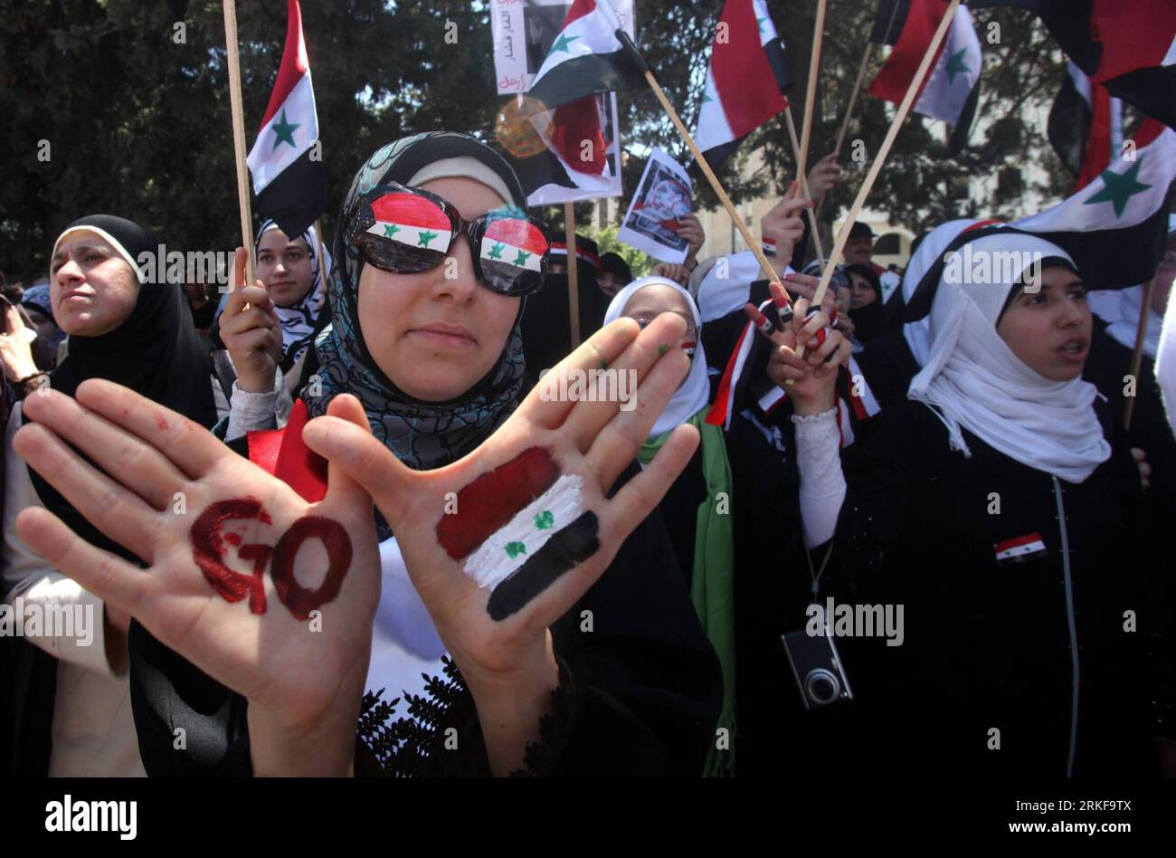 Bildnummer: 55384812 Datum: 21.05.2011 Copyright: imago/Xinhua (110521) -- AMMAN, 21 maggio 2011 (Xinhua) -- Una protesta siriana è vista con bandiere nazionali siriane dipinte su occhiali e mani durante una manifestazione davanti alla sede delle Nazioni Unite ad Amman, capitale della Giordania, il 21 maggio 2011, esortando le Nazioni Unite ad agire per fermare gli attacchi contro i civili in Siria da parte delle autorità di sicurezza siriane. (Xinhua/Mohammad Abu Ghosh) JORDAN-AMMAN-SYRIANS-DEMONSTRATION PUBLICATIONxNOTxINxCHN Gesellschaft Politik Demonstration Syrien premiumd kbdig xsp 2011 quer highlight o0 Hand, Bemalung, Fahne, N Foto Stock