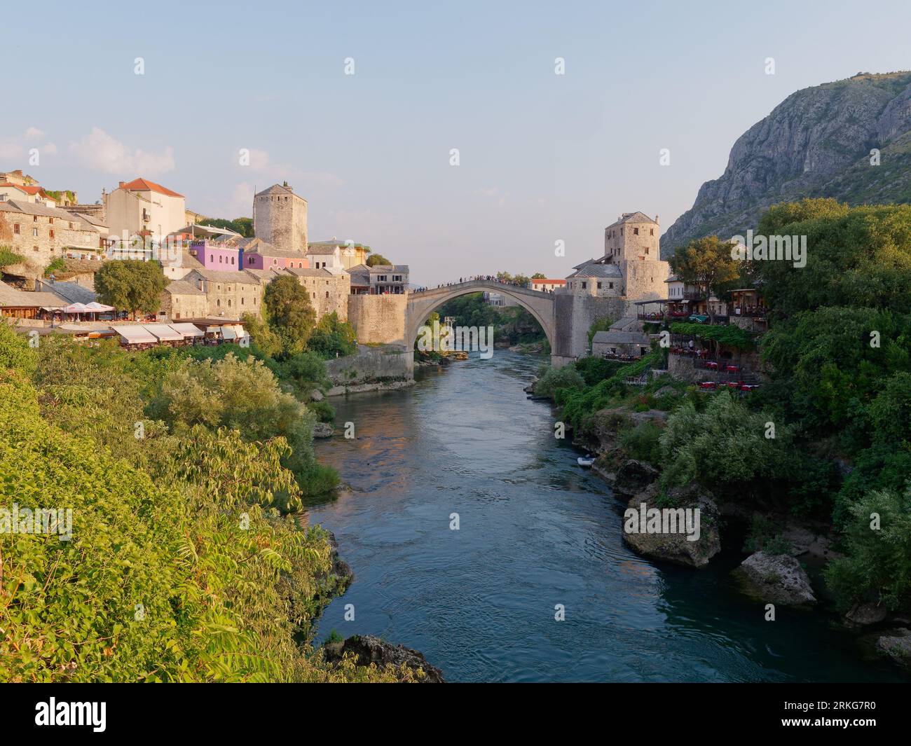 Stari Most (Ponte Vecchio) sul fiume Neretva a Mostar con la montagna a destra, Bosnia ed Erzegovina, 22 agosto 2023. Foto Stock