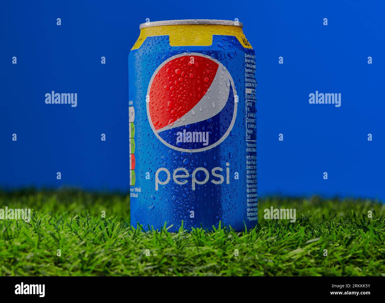 Mansfield, Nottingham, Regno Unito, 25 agosto 2023: Immagine del prodotto Studio di una lattina di Pepsi appoggiata su un'erba con uno sfondo blu. Foto Stock