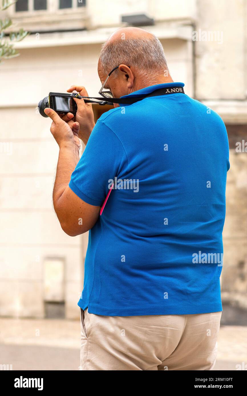 Vista posteriore di MAN con fotocamera mirrorless Sony che scatta foto - Tours, Indre-et-Loire (37), Francia. Foto Stock