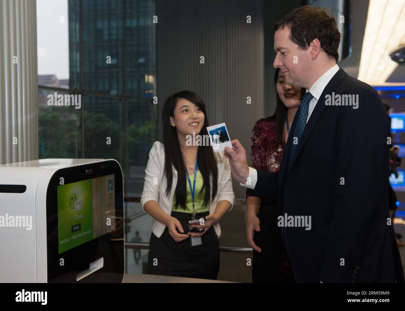 Bildnummer: 60605763 Datum: 16.10.2013 Copyright: imago/Xinhua (131016) -- SHENZHEN, 16 ottobre 2013 (Xinhua) -- il Cancelliere dello Scacchiere britannico George Osborne (R) sperimenta la stampa da Wechat, un'applicazione di messaggistica vocale e di testo mobile sviluppata dal portale di servizi Internet cinese Tencent, presso l'ufficio di Tecent Holdings Ltd. a Shenzhen, nella provincia del Guangdong della Cina meridionale, 16 ottobre 2013. Osborne ha visitato Huawei Technologies, il principale fornitore di soluzioni ICT a livello mondiale in Cina, e Tecent Holdings Ltd., il più grande player Internet cinese, con rappresentanti di oltre 20 aziende britanniche Foto Stock