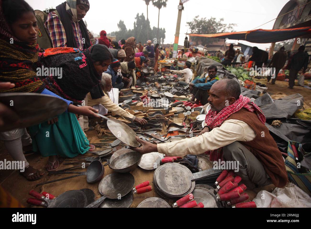 (140116) -- BENGALA OCCIDENTALE, (Xinhua) -- la gente compra cose al Joydev Kenduli Mela nel villaggio di Kenduli, Joydev nello Stato indiano del Bengala Occidentale, 15 gennaio 2014. Il Joydev Kenduli Mela, una grande fiera di tre giorni per commemorare il famoso poeta indiano Joyadeva che compose la gita Govinda, si è tenuta mercoledì. Decine di migliaia di turisti sono stati attratti da venire non solo per ascoltare i Bauls che cantano gli inni composti da Joyadeva, ma anche per gustare il sapore di un tipico mercato di campagna indiano, come incantatori di serpenti, cibo di strada e così via. (Xinhua/Zheng Huansong) INDIA-BENGALA OCCIDENTALE-JOYD Foto Stock