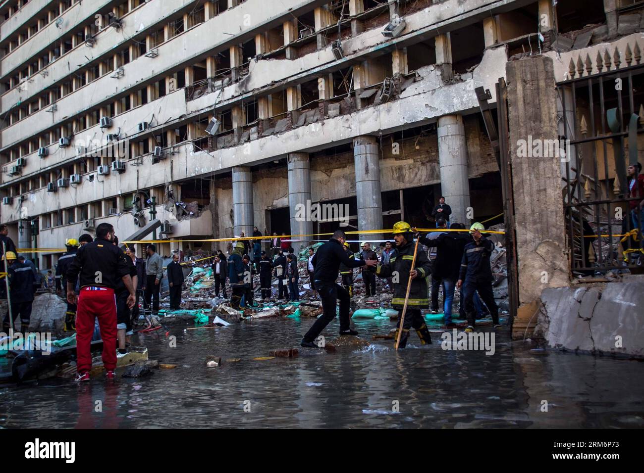 (140124) - CAIRO, JAN. 24, 2014 (Xinhua) - agenti di polizia e investigatori mettono in sicurezza il luogo di esplosione di fronte al quartier generale della polizia del Cairo. 24 gennaio 2014. Almeno quattro persone sono rimaste uccise in una potente esplosione che ha scosso un quartier generale di polizia nel centro del Cairo all'inizio di venerdì, secondo l'edizione online del giornale al Ahram. (Xinhua/Amru Salahuddien)(hy) EGITTO-CAIRO-ATTACK PUBLICATIONxNOTxINxCHN Cairo Jan 24 2014 XINHUA agenti di polizia e investigatori proteggono il sito di esplosione di fronte al quartier generale della polizia del Cairo Jan 24 2014 almeno quattro celebrità sono state UCCISE in una P. Foto Stock
