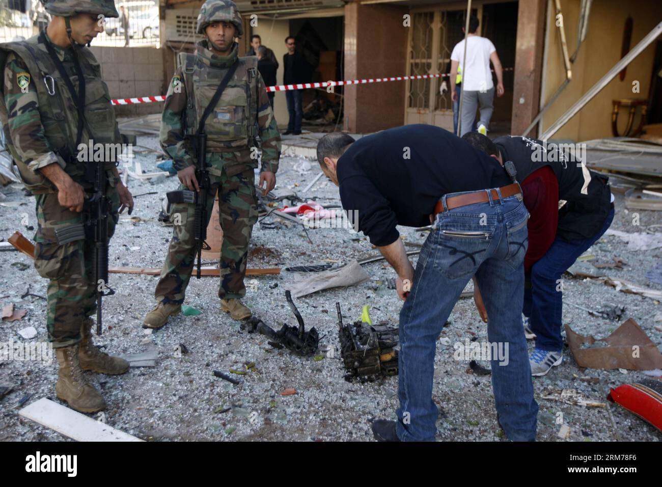 (140219) -- BEIRUT, 19 febbraio 2014 (Xinhua) -- i membri della sicurezza ispezionano il sito di un'esplosione suicida a Beirut, capitale del Libano. Mercoledì mattina, due colpi di suicidio hanno colpito la missione culturale iraniana nella capitale libanese di Beirut, uccidendo almeno due persone e ferendone altre 32, ha detto Aljadeed TV e testimoni oculari. Le Brigate Abdullah Azzam, un gruppo collegato ad al-Qaida, rivendicarono la responsabilità delle esplosioni gemelle. (Xinhua/Koka) LEBANON-BEIRUT-TWIN BLASTS PUBLICATIONxNOTxINxCHN Beirut 19 febbraio 2014 i membri della sicurezza di XINHUA ispezionano il sito di un'esplosione suicida a Beirut capitale del Libano Twi Foto Stock