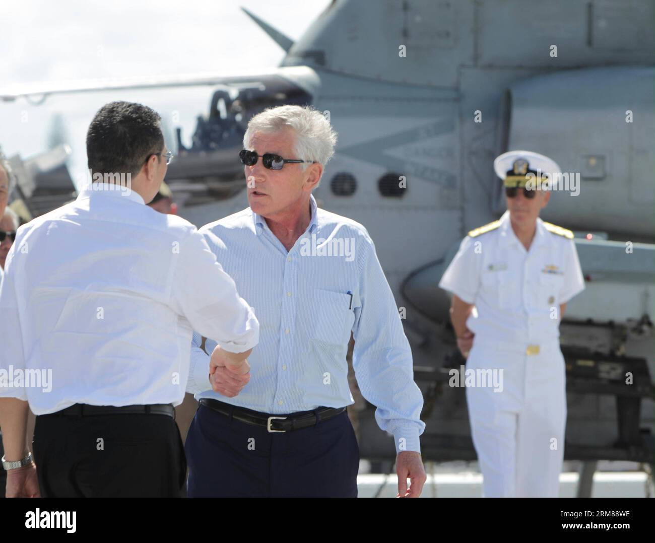 HONOLULU, 2 aprile 2014 (Xinhua) -- il segretario della difesa statunitense Chuck Hagel (2nd R) stringe la mano al ministro della difesa malese e al ministro dei trasporti ad interim Hishammuddin Hussein sul ponte di volo della USS Anchorage, una nave anfibia da trasporto presso la base congiunta Pearl Harbor-Hickam a Honolulu, Hawaii, Stati Uniti, il 2 aprile 2014. Mercoledì, il segretario alla difesa degli Stati Uniti Chuck Hagel si è impegnato a continuare a fornire assistenza agli Stati Uniti per la ricerca del volo MH370 della Malaysia Airlines scomparso. Ha detto di aver incontrato il ministro della difesa malese e il ministro dei trasporti ad interim Hishammuddin Hussein durante il Foto Stock