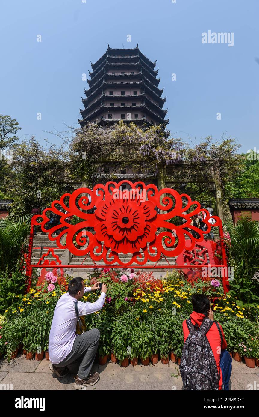 (140410) -- HANGZHOU, 10 aprile 2014 (Xinhua) -- i turisti scattano foto di fiori di peonia vicino alla Pagoda di Liuhe, letteralmente una pagoda di sei armonie, a Hangzhou, capitale della provincia dello Zhejiang della Cina orientale, 10 aprile 2014. La pagoda ha riaperto al pubblico il giovedì dopo un anno di ristrutturazione. (Xinhua/Xu Yu) (mp) CHINA-HANGZHOU-LIUHE PAGODA-REOPEN (CN) PUBLICATIONxNOTxINxCHN 140.410 Hangzhou 10 aprile 2014 i turisti di XINHUA scattano foto di fiori di peonia vicino alla Pagoda letteralmente una Pagoda di sei armonie a Hangzhou capitale della provincia dello Zhejiang della Cina orientale 10 aprile 2014 la PAGODA ha riaperto alla Foto Stock