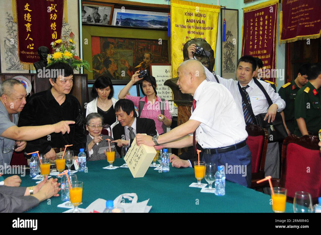 (140424) -- HANOI, 24 aprile 2014 (Xinhua) -- il defunto generale cinese Chen Geng S Son Chen Zhijian (R) fornisce alcuni meteriali storici sul generale vietnamita Vo Nguyen Giap a quest'ultimo figlio Vo Dien Bien (2nd L) nella capitale del Vietnam Hanoi il 24 aprile 2014. Una delegazione di ex esperti cinesi e le loro famiglie hanno visitato la residenza del defunto generale vietnamita Vo Nguyen Giap ad Hanoi e hanno incontrato i membri della famiglia di Giap. (Xinhua/Zhang Jianhua) VIETNAM-HANOI-CHINA-VISIT PUBLICATIONxNOTxINxCHN Hanoi 24 aprile 2014 XINHUA Chinese late General Chen Geng S Sun Chen Zhijian r dà così Foto Stock