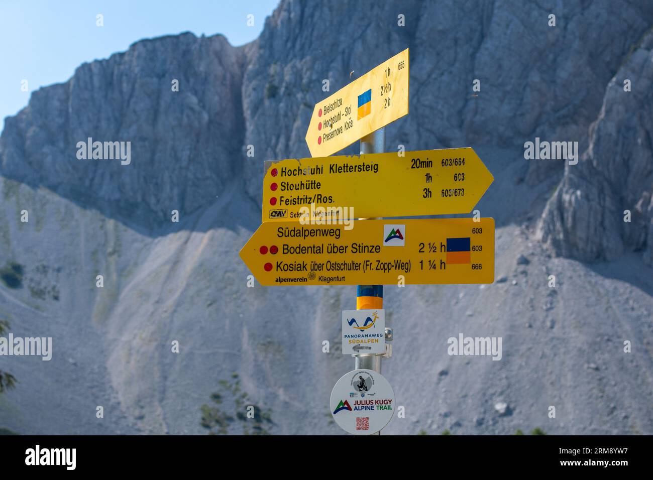Feistritz im Rosental, Austria - 26 giugno 2022: Cartellone che mostra le distanze per le destinazioni escursionistiche sullo sfondo del monte Bielschitza Foto Stock