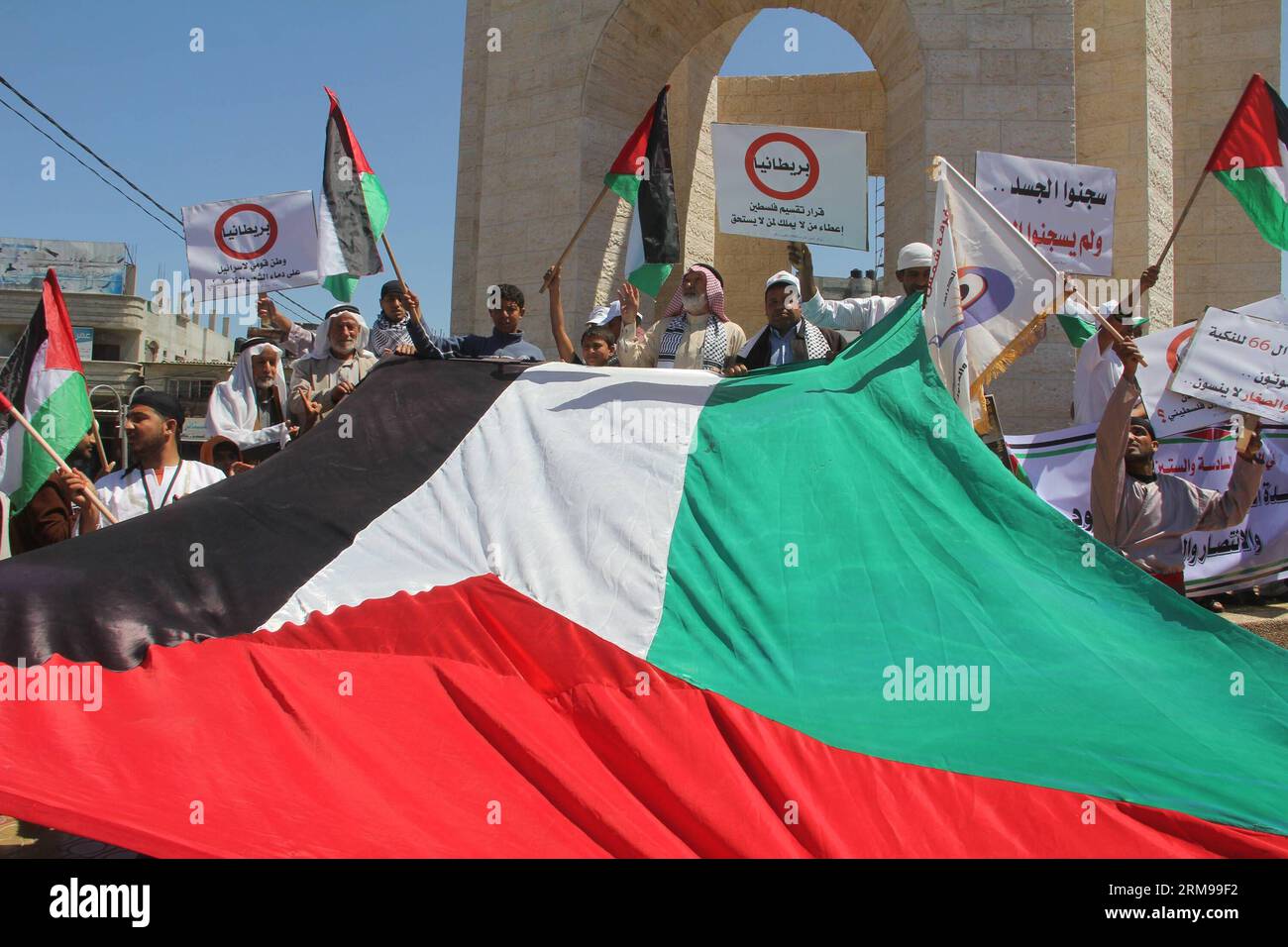 (140514) -- GAZA, 14 maggio 2014 (Xinhua) -- i palestinesi detengono una grande bandiera nazionale durante una manifestazione in vista del 66° anniversario di Nakba nella città meridionale di Rafah, nella Striscia di Gaza, il 14 maggio 2014. I palestinesi segneranno Nakba (catastrofe) il 15 maggio per commemorare centinaia di migliaia di palestinesi in fuga dalle loro case durante la guerra del 1948. (Xinhua/Khaled Omar) (zjy) MIDEAST-GAZA-NAKBA PUBLICATIONxNOTxINxCHN Gaza 14 maggio 2014 XINHUA PALESTINESE detiene una grande bandiera nazionale durante un raduno in vista dell'anniversario di Nakba nella Striscia meridionale di Gaza città di Rafah IL 14 maggio 2014 PALESTINESI wi Foto Stock