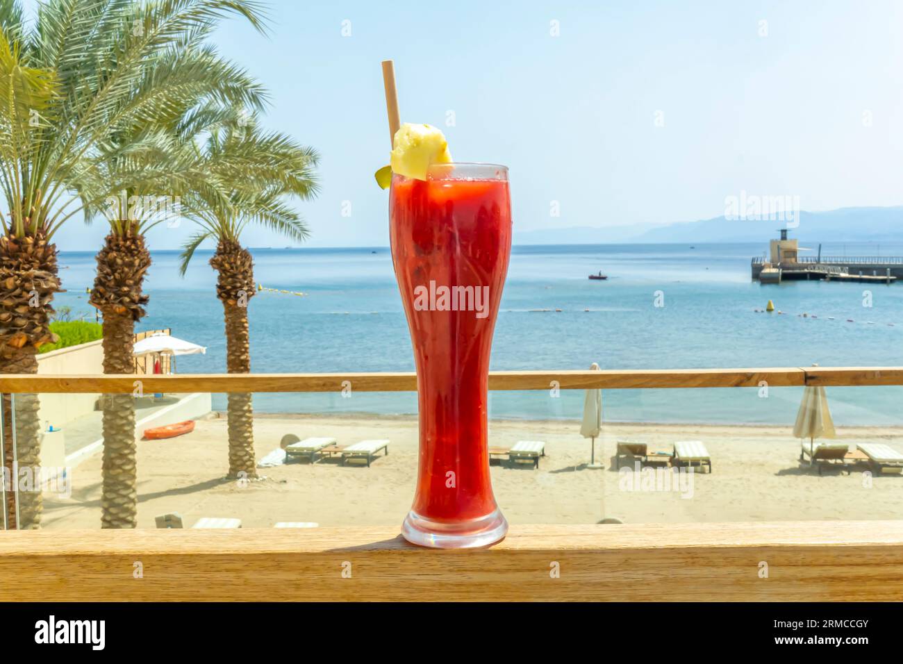 Bicchiere di frullato di succo di fragole con limone in un paesaggio tropicale, mare arabo. Concetto di drink in resort sulle spiagge tropicali Foto Stock