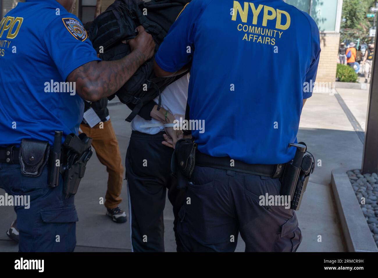 NEW York, NEW YORK - AGOSTO 27: Un contromanifestante viene arrestato durante una manifestazione anti-migrante e protesta fuori dalla Gracie Mansion il 27 agosto 2023 a New York. Il fondatore dei Guardian Angels Curtis Sliwa fu raggiunto da funzionari locali e centinaia di manifestanti, mentre tenne un'altra protesta anti-migrante dopo aver messo in scena diversi a Brooklyn e Queen contro i rifugi di soccorso dei migranti nei quartieri. La polizia di New York ha fatto diversi arresti, tra cui Sliwa che è stato arrestato per disobbedienza civile. Secondo gli ultimi dati della città, ci sono più di 59.000 migranti nei rifugi cittadini, con centinaia di altri Foto Stock