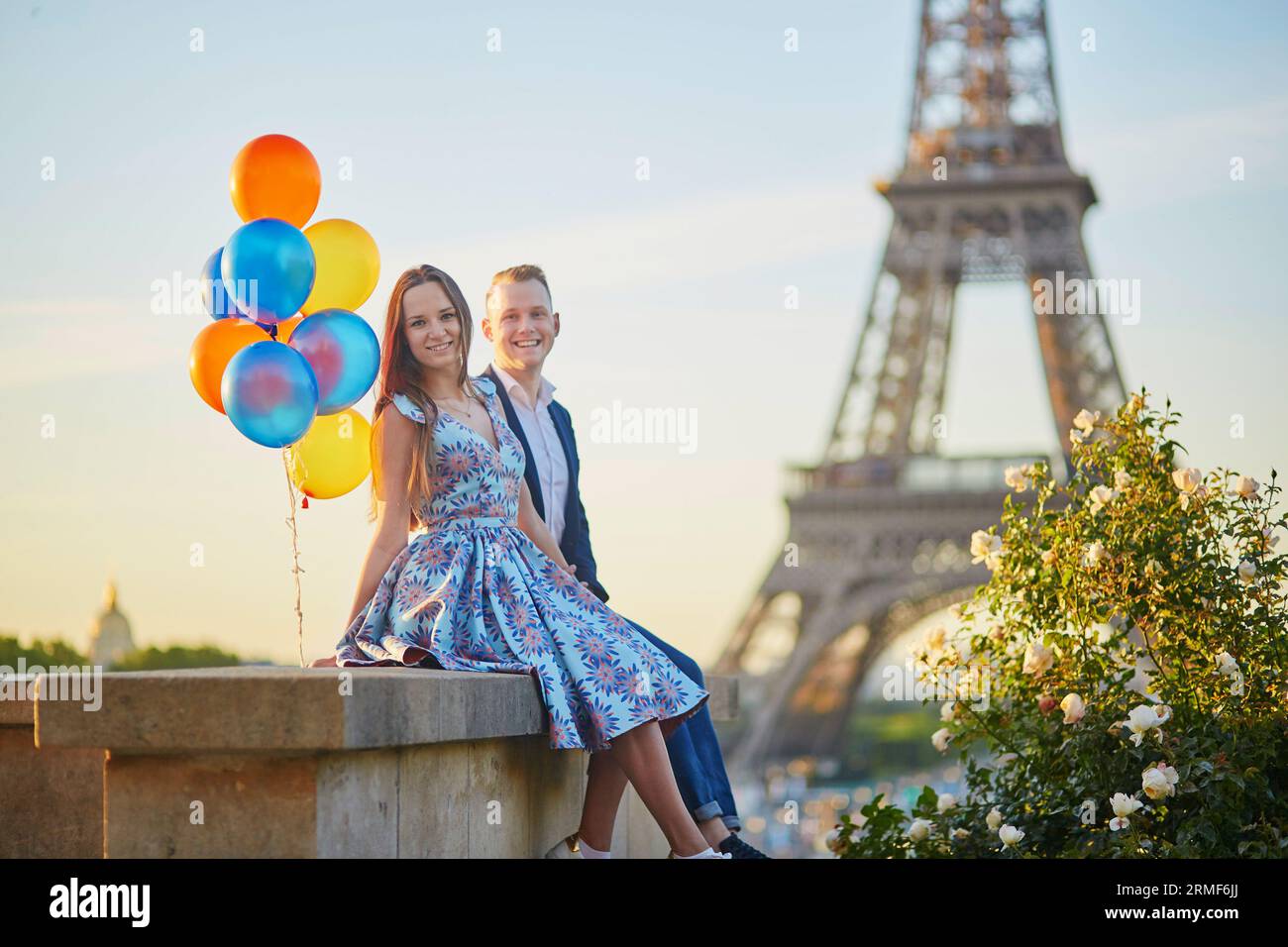 Coppia amorevole con un sacco di palloncini colorati che si baciano vicino alla Torre Eiffel a Parigi, in Francia Foto Stock