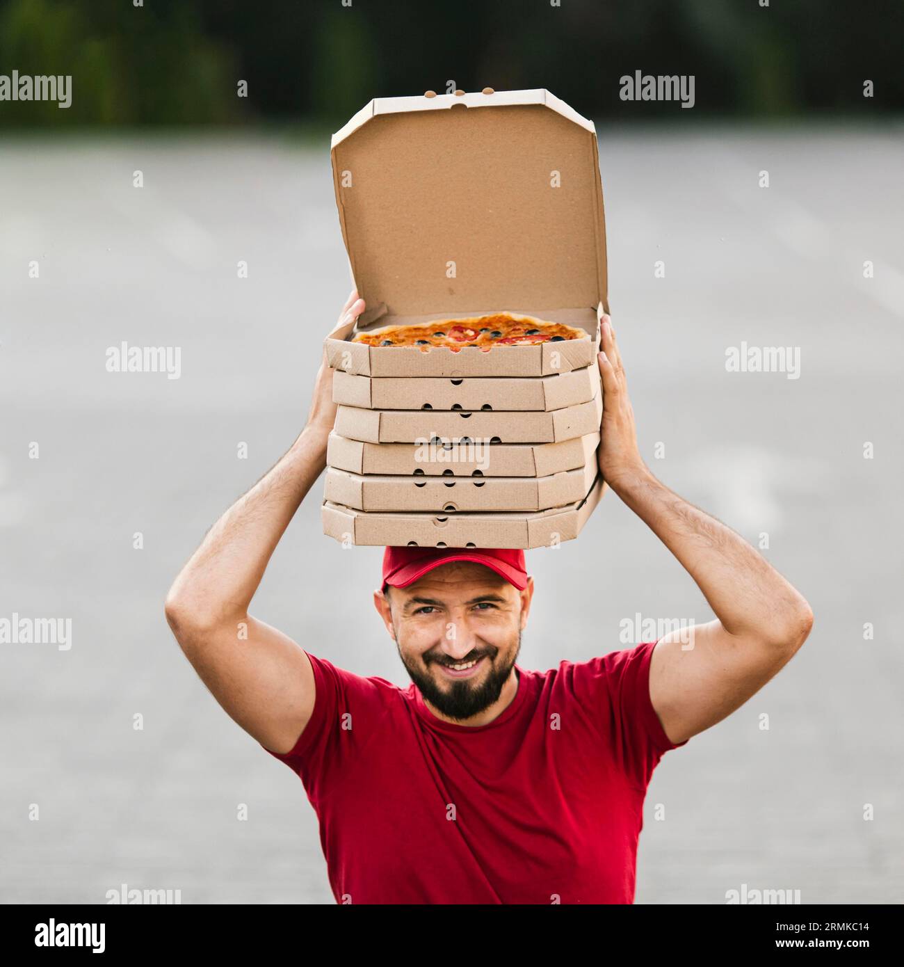 Addetto al servizio di consegna con la sua testa per la pizza Foto Stock