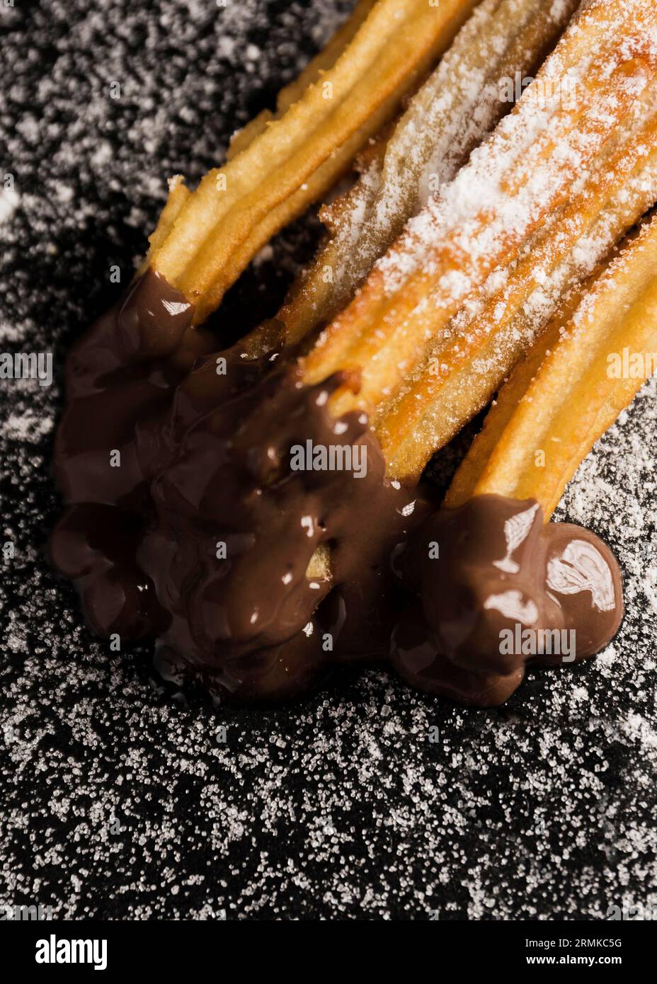 Churros vista alta con cioccolato di zucchero Foto Stock