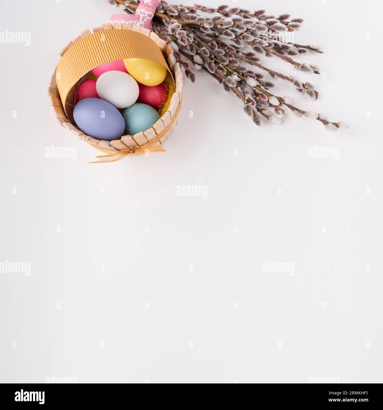Cestino di legno con uova di Pasqua e rami di salice Foto Stock