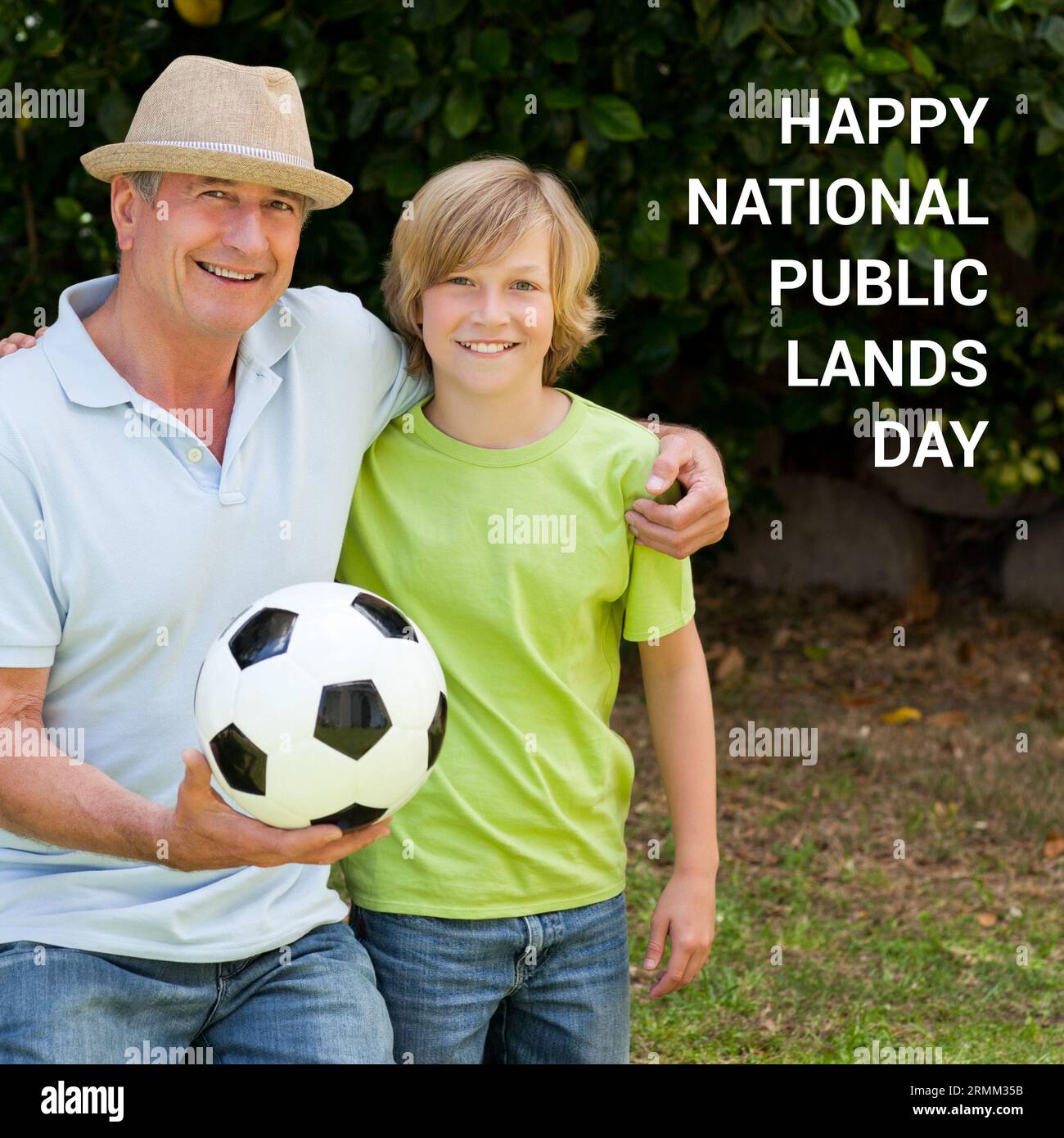 Composito di felice pubblico nazionale terra giorno testo su padre e figlio caucasico con palla nel parco Foto Stock
