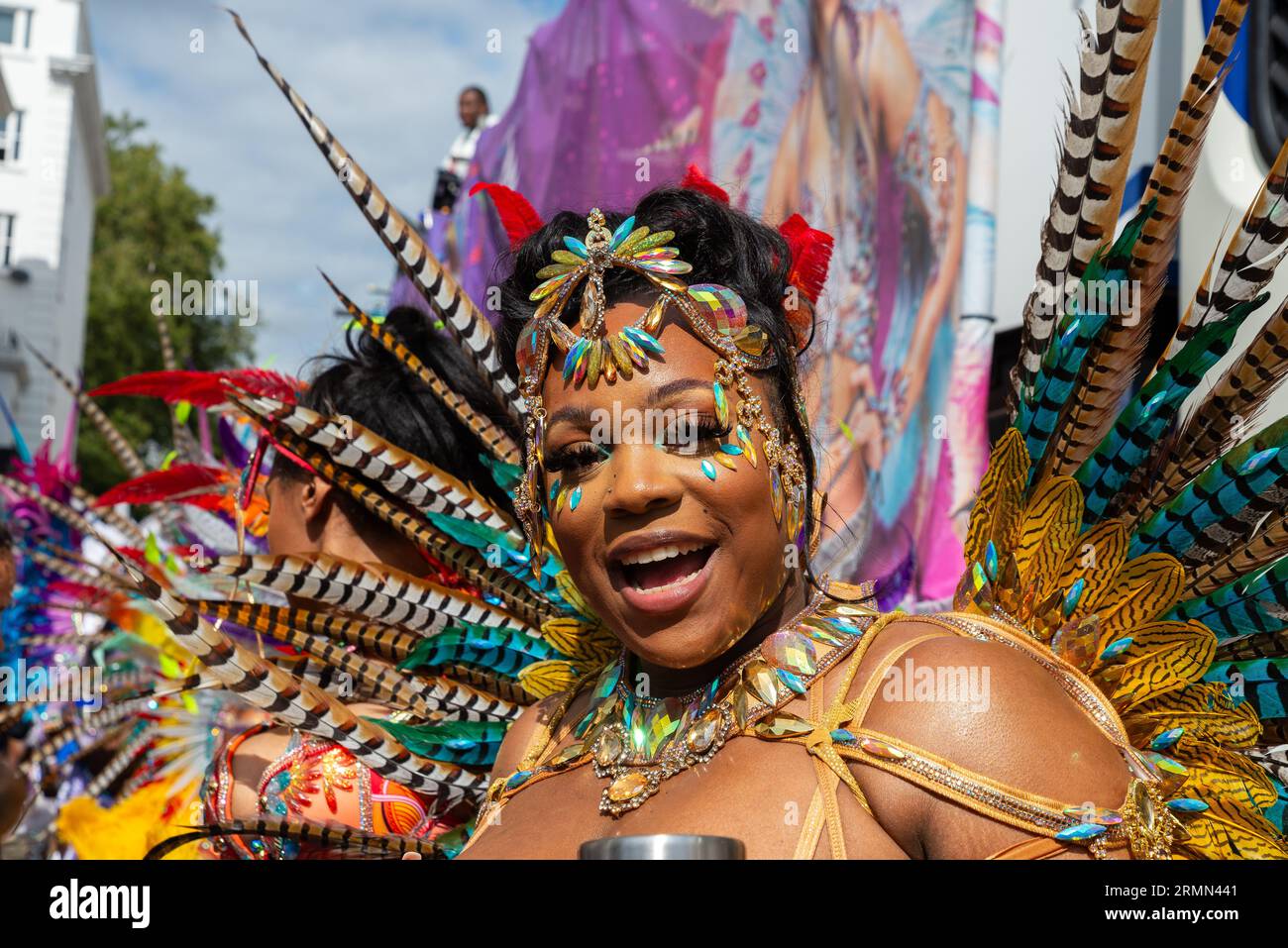 Partecipante femminile alla Notting Hill Carnival Grand Parade 2023, Londra, Regno Unito. Costume colorato di strass e piume Foto Stock