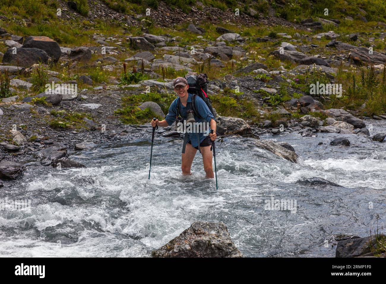 A seconda delle condizioni del sentiero e della profondità dell'acqua nel fiume, la guida escursionistica attraverso Tusheti (Georgia) decide a quale punto sarà attraversato il fiume Foto Stock