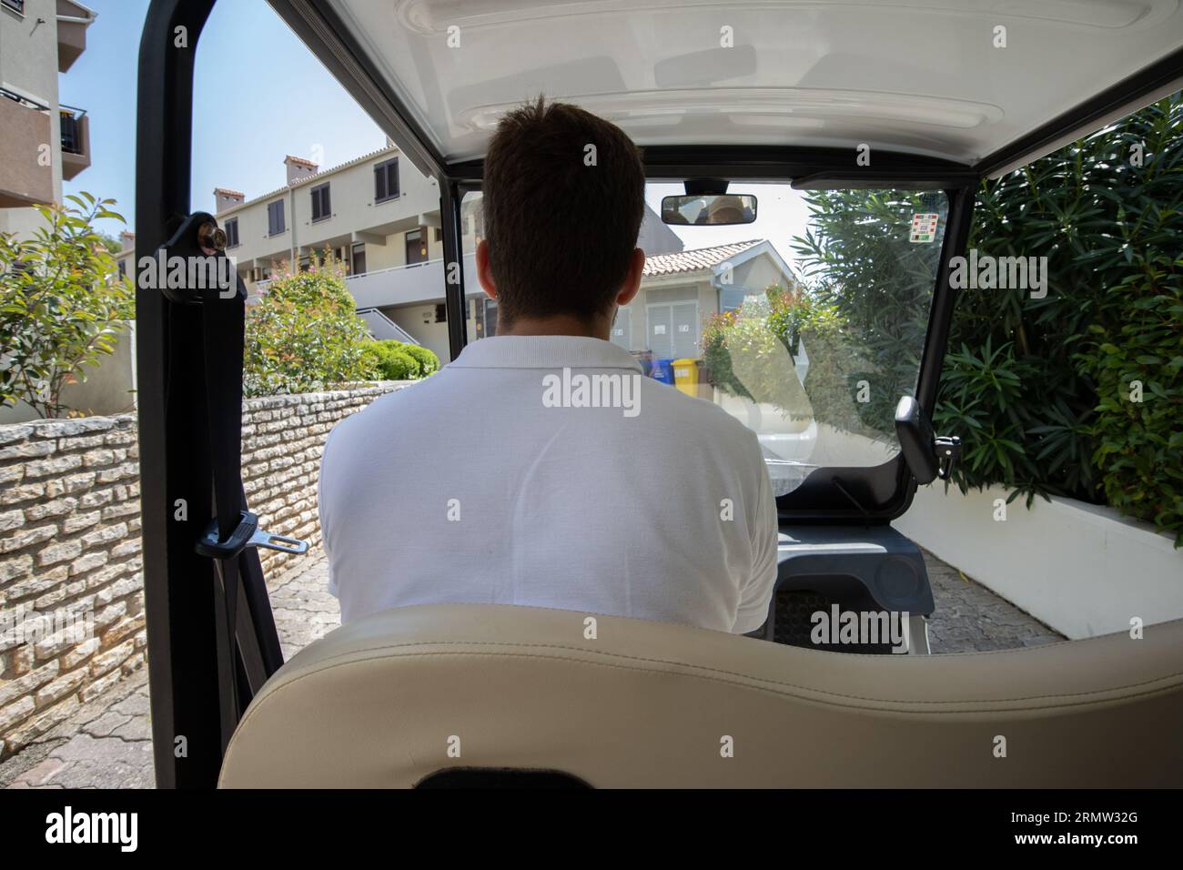 Un rappresentante di Holiday Resort guida un resort buggy intorno agli chalet del resort, Croazia, Europa Foto Stock
