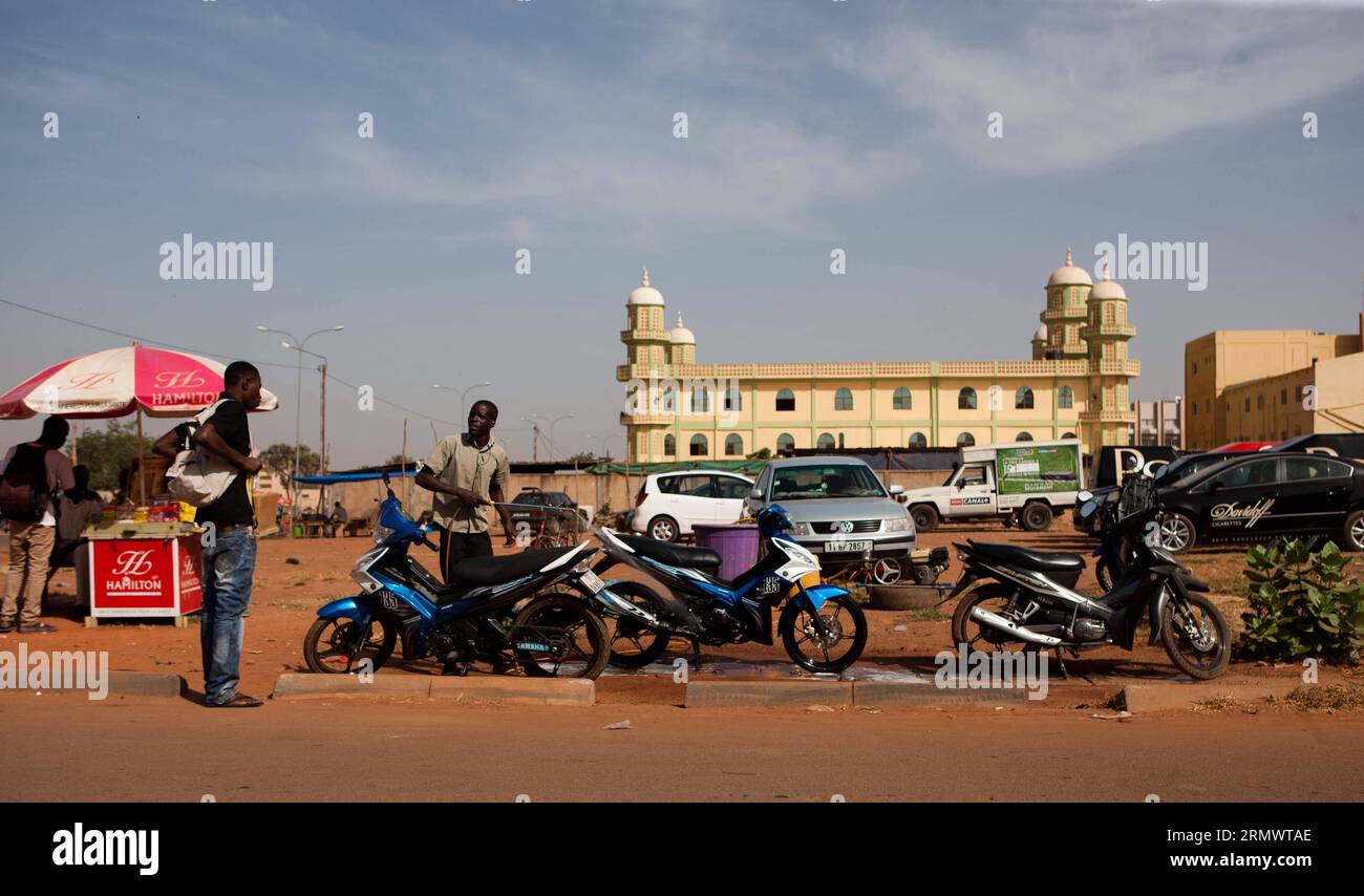 (141110) - OUAGADOUGOU, 10 novembre 2014. Un uomo aspetta che la sua moto venga lavata a Ouagadougou, capitale del Burkina Faso, 10 novembre 2014. (Dzl) BURKINA FASO-OUAGADOUGOU-STREET VIEW LixJing PUBLICATIONxNOTxINxCHN Ouagadougou Nov 10 2014 un uomo attende che la sua motocicletta venga lavata a Ouagadougou capitale del Burkina Faso Nov 10 2014 dzl Burkina Faso Ouagadougou Street View PUBLICATIONTxINxINxCHN Foto Stock