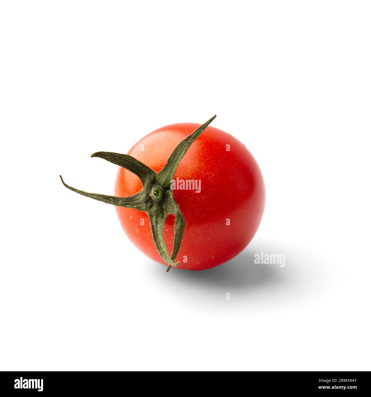 One fresh organic cherry tomato with green tail isolated on white background closeup. Products for a healthy diet. Foto Stock