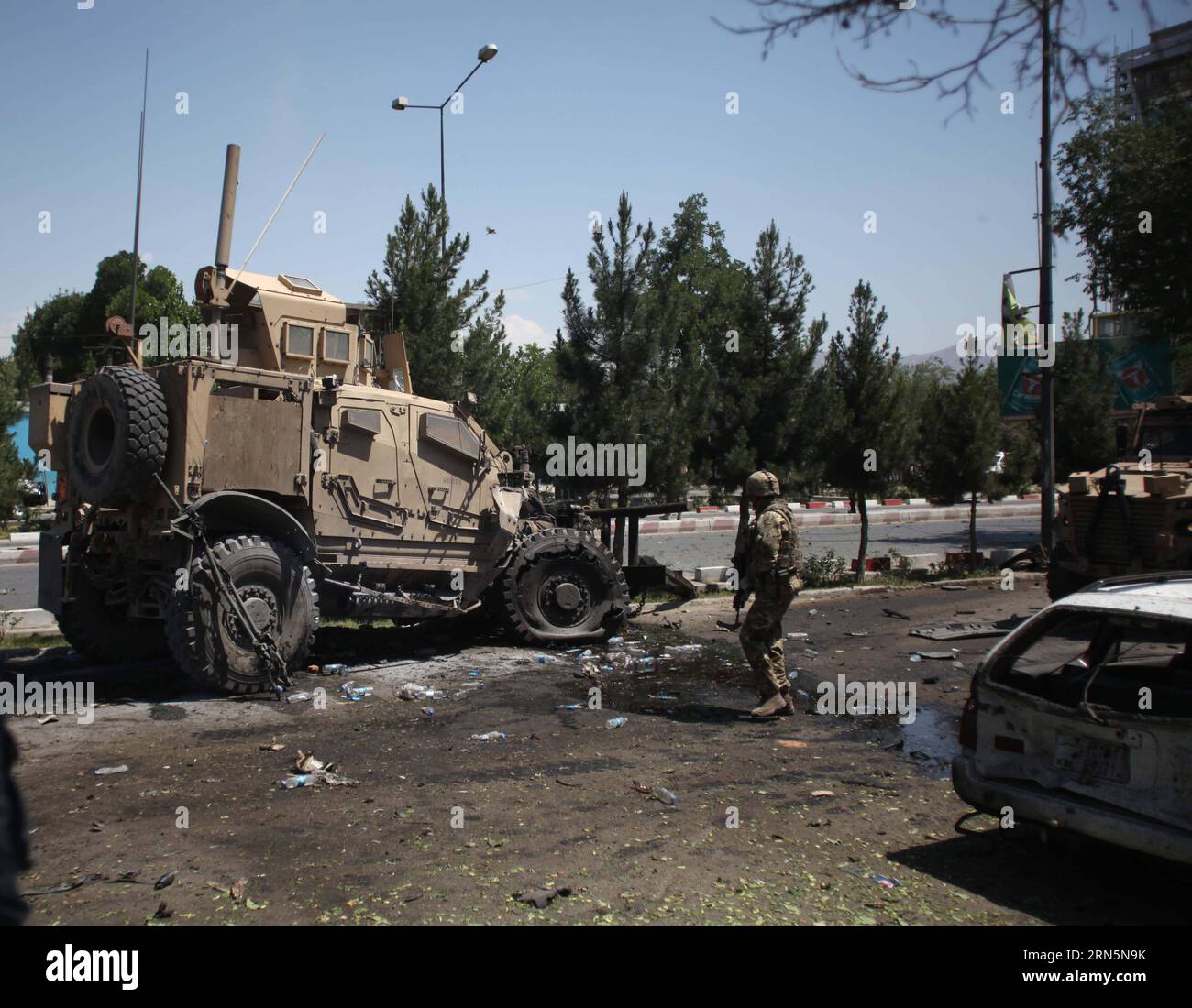 (150630) - KABUL, 30 giugno 2015 - Un soldato straniero cammina intorno a un veicolo militare distrutto a seguito di un attentato suicida a Kabul, Afghanistan, 30 giugno 2015. Almeno una persona è stata confermata morta e altre 22 feriti mentre un attentatore suicida ha fatto saltare in aria la sua auto carica di esplosivo accanto a un convoglio della missione Resolute Support (RS) guidata dalla NATO nella capitale afghana Kabul martedì, portavoce del Ministero dell'interno, Sediq Sediqi Said . ) AFGHANISTAN-KABUL-NATO CONVOGLIO-ATTACCO AhmadxMassoud PUBLICATIONxNOTxINxCHN 150630 Kabul giugno 30 2015 un soldato straniero cammina intorno a un veicolo militare distrutto f Foto Stock