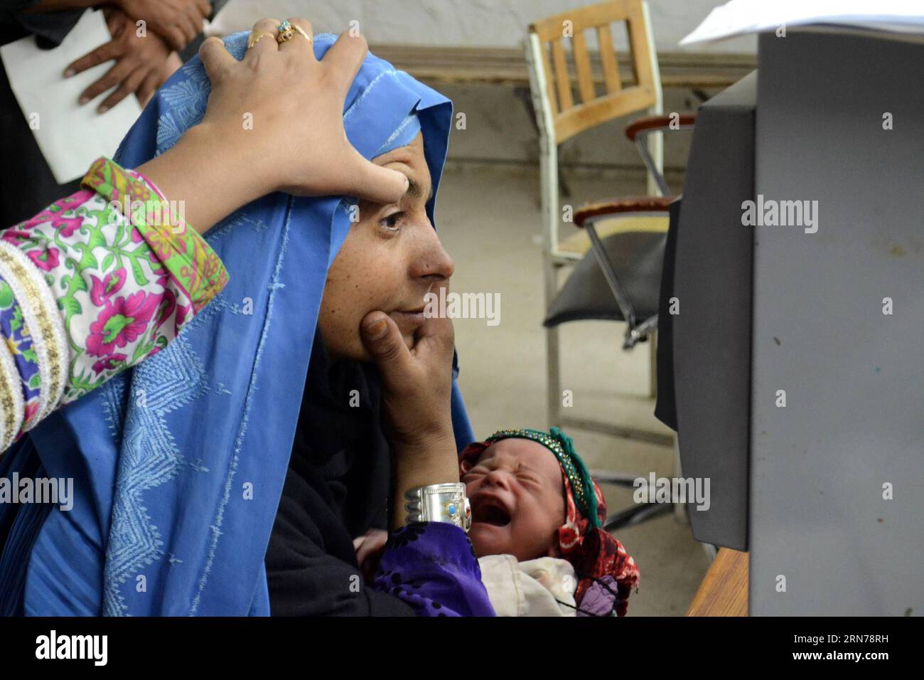 (150826) -- QUETTA, 26 agosto 2015 -- un dipendente dell'alto Commissariato delle Nazioni Unite per i rifugiati (UNHCR) scansiona un occhio di una donna rifugiata afghana in un centro di registrazione dell'UNHCR nel sud-ovest del Pakistan, Quetta, 26 agosto 2015. Attualmente ci sono 1,5 milioni di rifugiati afghani registrati in Pakistan. ) (lrz) PAKISTAN-QUETTA-AFGHANISTAN-REFUGEES Asad PUBLICATIONxNOTxINxCHN 150826 Quetta Aug 26 2015 a dipendente dell'alto Commissariato delle Nazioni Unite per i rifugiati l'UNHCR esegue scansioni di Eye of to Afghan Refugee Woman AT a UNHCR Registration Centre in Southwest Pakistan S Quetta Aug 26 2015 Foto Stock