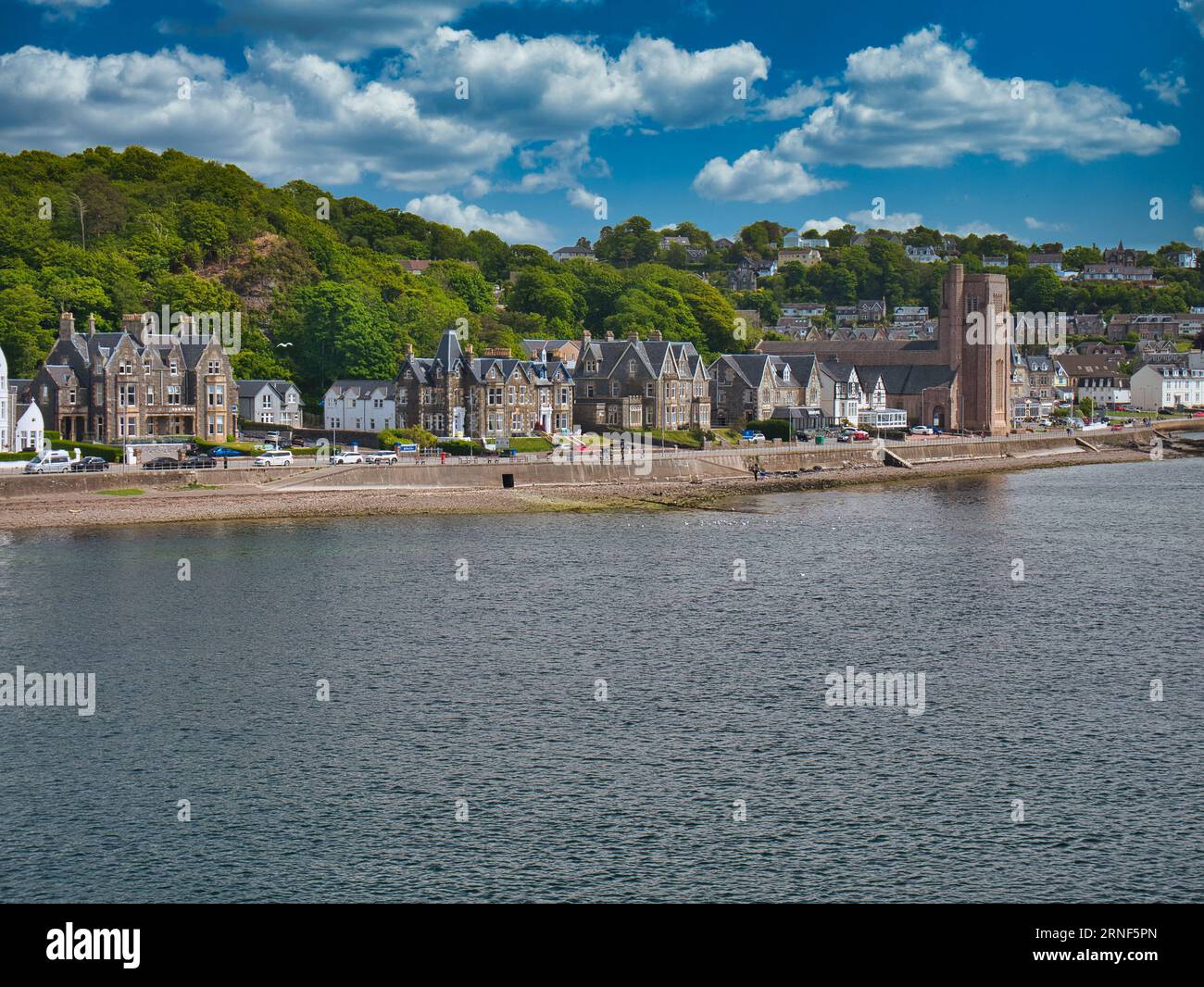 Corran Esplanade a Oban dal traghetto a barra passando attraverso Oban Bay - gli hotel e la Cattedrale di San Columba appaiono sulla destra dell'immagine, con t Foto Stock