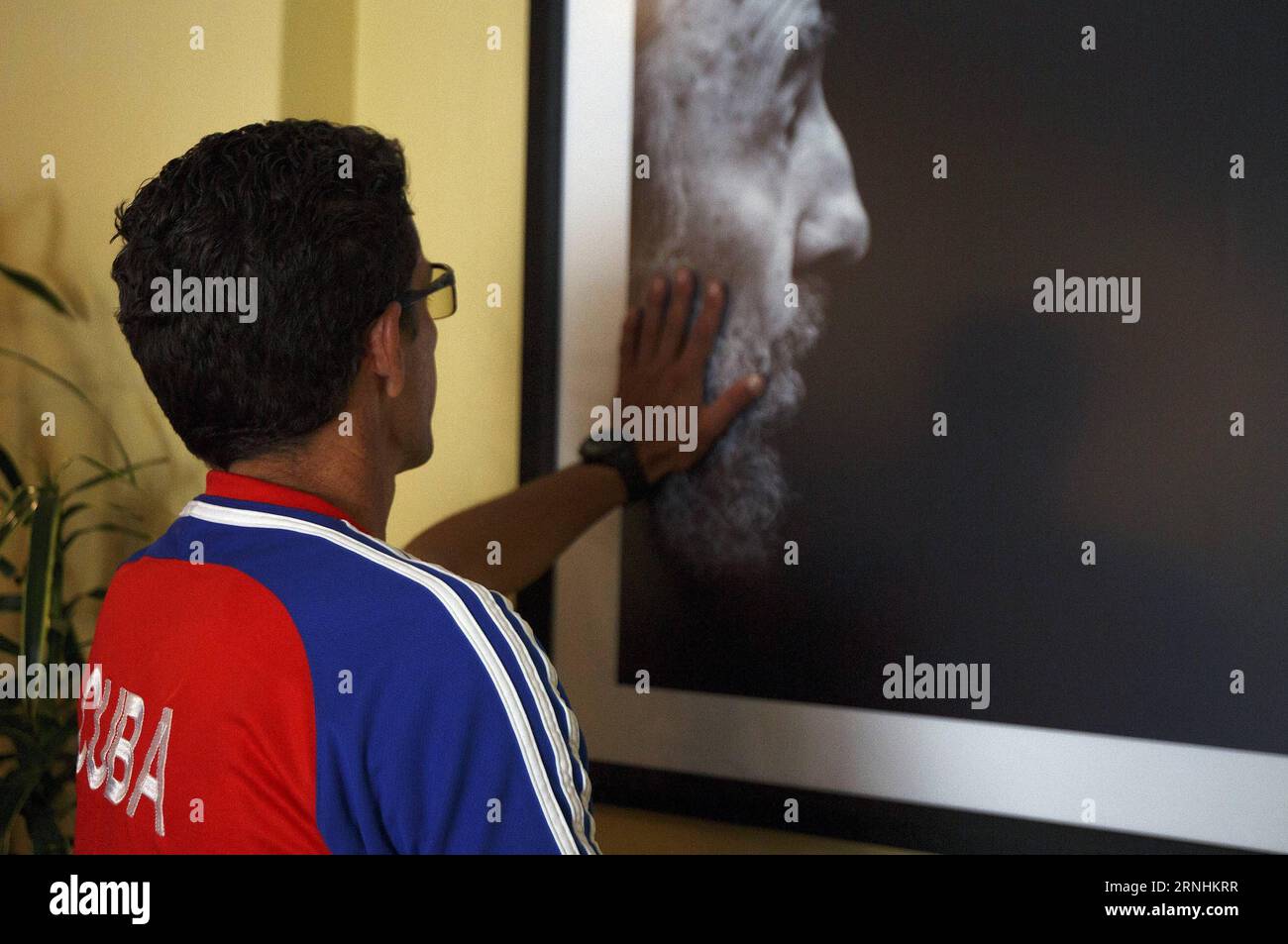 Un residente cubano tocca una foto dell'ex leader rivoluzionario cubano Fidel Castro, all'interno dell'ambasciata cubana dopo la sua morte, a Quito, Ecuador, 26 novembre 2016. 90 anni, Castro è morto venerdì sera tardi. ) (Zjy) ECUADOR-QUITO-CUBA-FIDEL CASTRO SantiagoxArmas PUBLICATIONxNOTxINxCHN Foto Stock