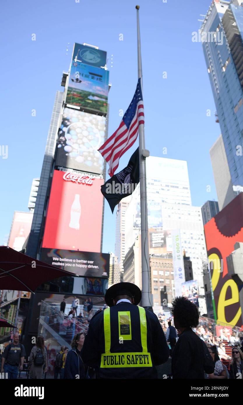 (171003) -- NEW YORK, 3 ottobre 2017 -- Una guardia di sicurezza di Times Square si trova di fronte a una bandiera nazionale degli Stati Uniti che sventola a mezz'asta per piangere le vittime di una sparatoria di massa a Las Vegas, a Times Square a New York, negli Stati Uniti, il 3 ottobre 2017. Almeno 59 persone sono state uccise e 527 altre ferite dopo che un uomo armato ha aperto il fuoco domenica in un concerto a Las Vegas nello stato americano del Nevada, il più letale sparatoria di massa nella storia moderna degli Stati Uniti. ) U.S.-NEW YORK-LAS VEGAS-TIRO-BANDIERA-MEZZO ALBERO LIXRUI PUBLICATIONXNOTXINXCHN Foto Stock