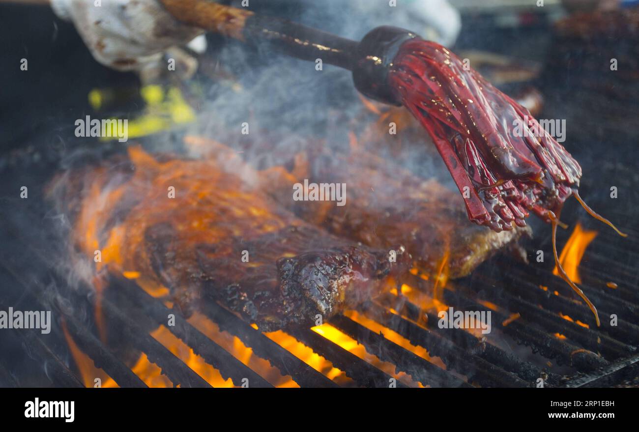 (180630) -- TORONTO, 30 giugno 2018 -- Un barbequer aggiunge uno spesso strato di salsa barbecue alle costolette durante il Toronto Ribfest 2018 a Toronto, Canada, 29 giugno 2018. L'evento annuale della durata di quattro giorni è iniziato venerdì per attirare migliaia di mangiatori. ) (Djj) CANADA-TORONTO-RIBFEST ZouxZheng PUBLICATIONxNOTxINxCHN Foto Stock