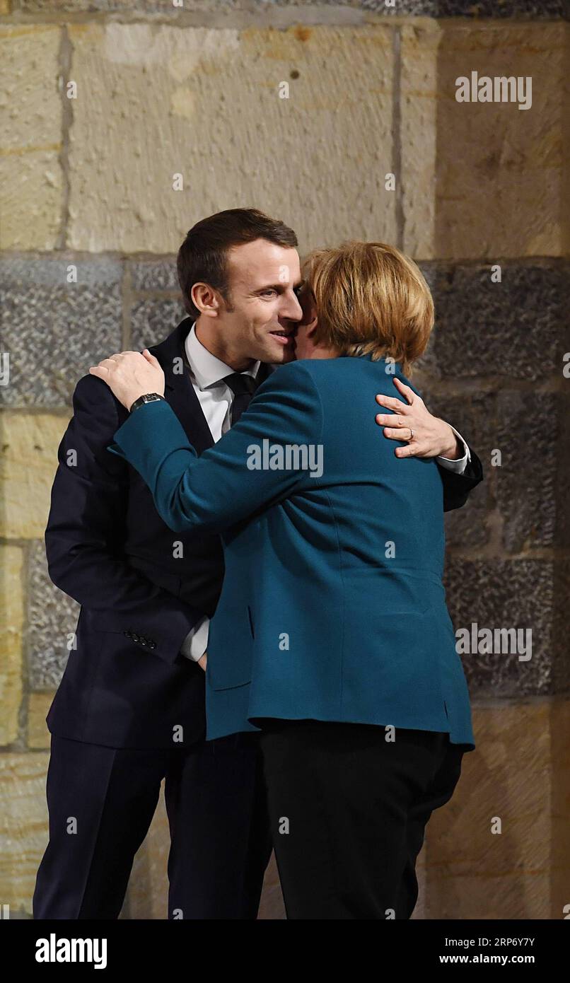 (190122) -- AQUISGRANA, 22 gennaio 2019 (Xinhua) -- la cancelliera tedesca Angela Merkel (R) e il presidente francese Emmanuel Macron reagiscono alla cerimonia di firma del trattato di Aquisgrana ad Aquisgrana, in Germania, il 22 gennaio 2019. La cancelliera tedesca Angela Merkel e il presidente francese Emmanuel Macron hanno firmato martedì un contratto per rinnovare l'amicizia e la cooperazione tra i due paesi. Il cosiddetto trattato di Aquisgrana, firmato da Merkel e Macron, mira a una più stretta cooperazione tra Germania e Francia in campo economico, di difesa e di politica europea. Il trattato di Aquisgrana si lega al trattato Elysee, firmato nel 1963. (X Foto Stock