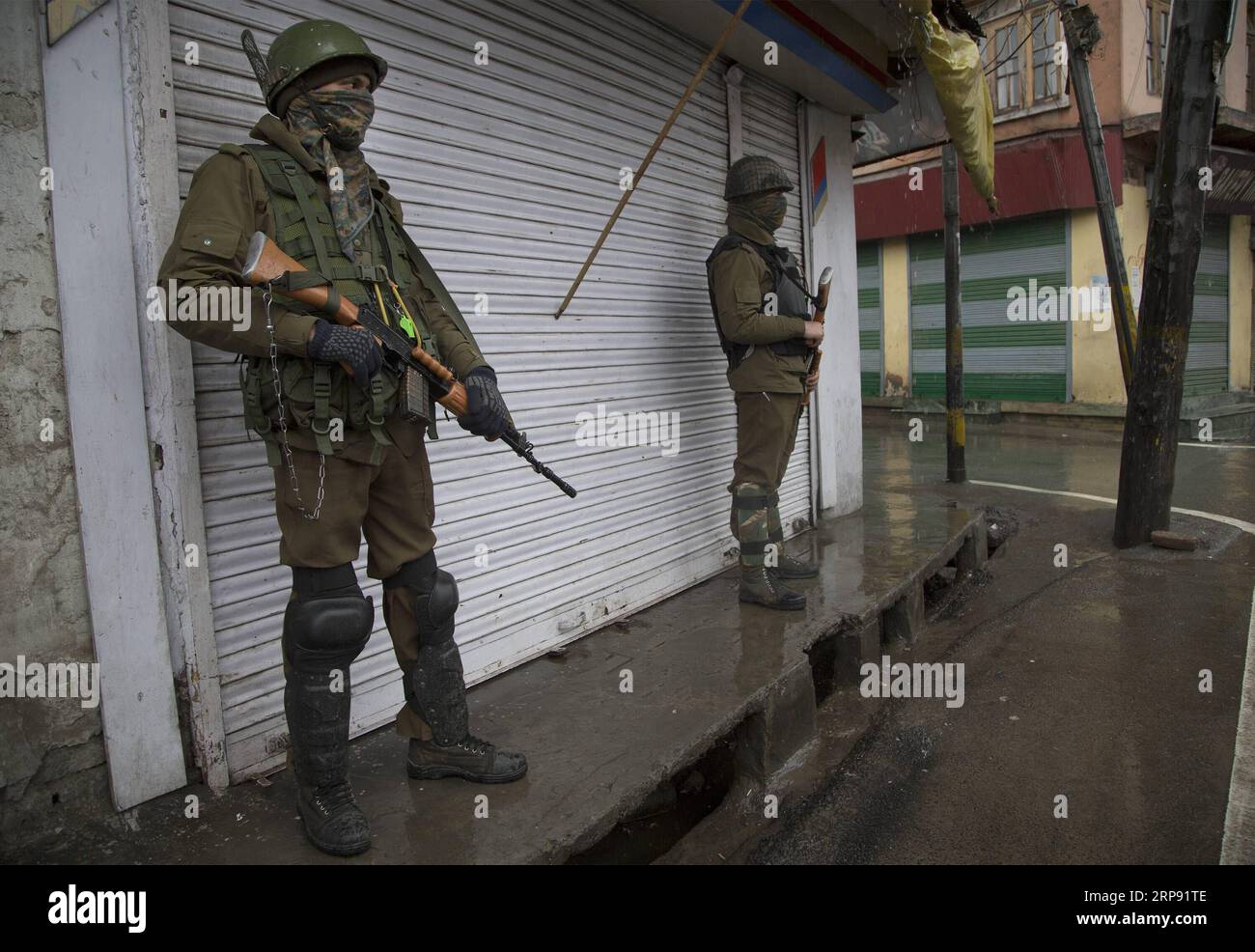 (190320) -- SRINAGAR, 20 marzo 2019 (Xinhua) -- i soldati paramilitari indiani stanno di guardia davanti a un negozio chiuso durante il blocco della sicurezza a Srinagar, la capitale estiva del Kashmir controllato dagli indiani, 20 marzo 2019. La vita normale nelle aree a maggioranza musulmana del Kashmir restive controllato dall'India mercoledì è rimasta colpita a causa di uno sciopero sulla morte custode di un insegnante di scuola. L'appello allo sciopero è stato dato dai gruppi separatisti della regione sotto la bandiera della Joint Resistance Leadership (JRL). (Xinhua/Javed Dar) KASHMIR-SRINAGAR-LOCKDOWN PUBLICATIONxNOTxINxCHN Foto Stock