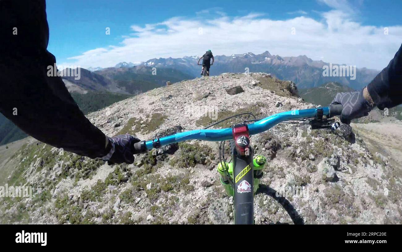Fai POV tra le mani di un mountain bike sulla cresta di una cresta di montagna Foto Stock