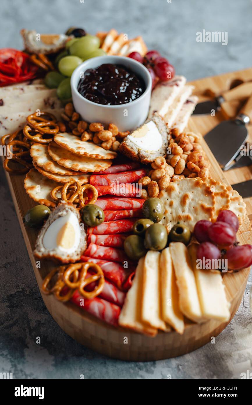 Una vasta gamma di deliziosi spuntini, tra cui formaggio, olive, uva e cracker Foto Stock