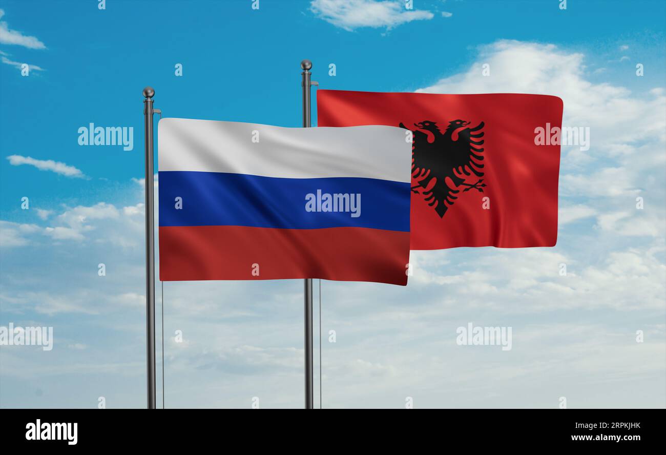 Bandiera russa e bandiera albanese che sventolano insieme nel vento sul cielo blu Foto Stock