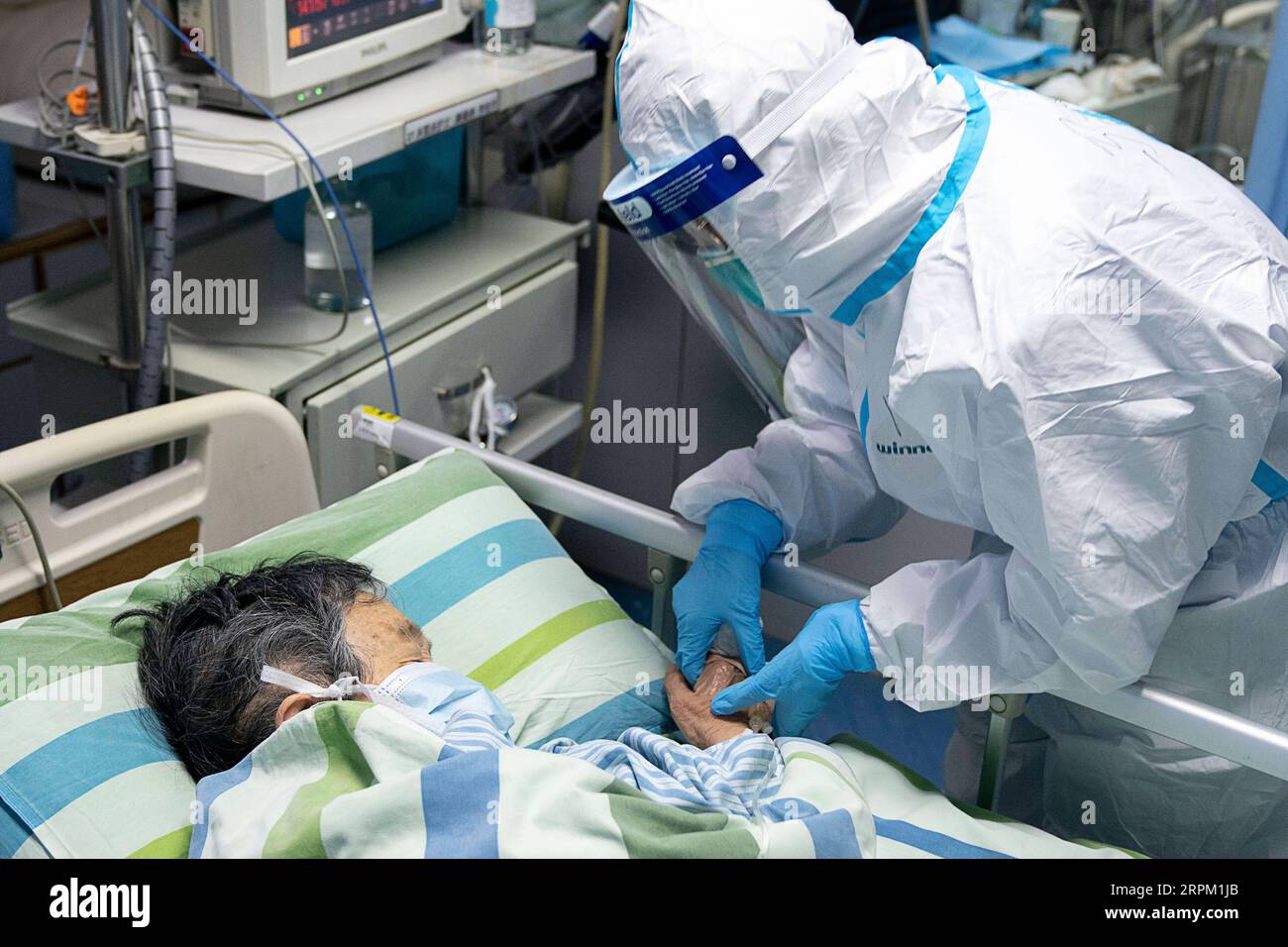 200124 -- WUHAN, 24 gennaio 2020 -- l'infermiera capo ma Jing tiene la mano di un paziente per confortarla nell'unità di terapia intensiva di terapia intensiva dell'ospedale Zhongnan dell'Università di Wuhan, provincia di Hubei, Cina centrale, 24 gennaio 2020. Giovedì a mezzanotte, la provincia di Hubei nella Cina centrale ha riportato 549 casi cumulativi confermati di nuova polmonite da coronavirus, con 495 a Wuhan, la capitale provinciale. CHINA-HUBEI-WUHAN-OPERATORE MEDICO CN XIONGXQI PUBLICATIONXNOTXINXCHN Foto Stock