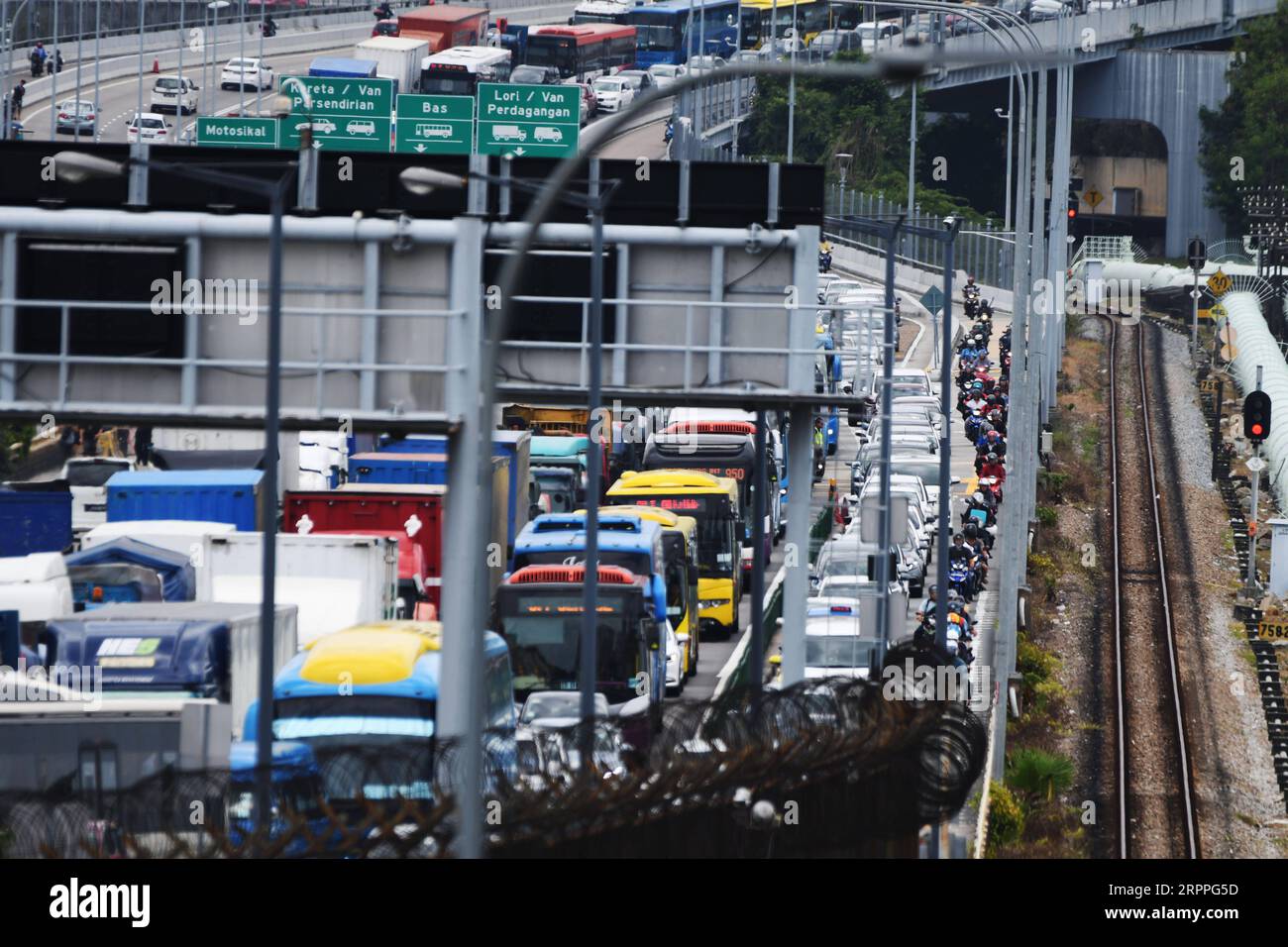 200317 -- SINGAPORE, 17 marzo 2020 Xinhua -- i veicoli in viaggio per Singapore dalla Malesia causano un inceppamento sulla Singapore-Johor Causeway il 17 marzo 2020. La Malaysia sta introducendo misure restrittive globali, tra cui la chiusura di negozi e scuole e l'imposizione di divieti di viaggio, nel tentativo di contenere l'epidemia di COVID-19, il primo ministro Muhyiddin Yassin ha annunciato lunedì. Le misure entreranno in vigore dal 18 marzo al 31 marzo, ha detto Muhyiddin. Foto di allora Chih Wey/Xinhua SINGAPORE-MALAYSIA-COVID-19-MEASURES PUBLICATIONxNOTxINxCHN Foto Stock