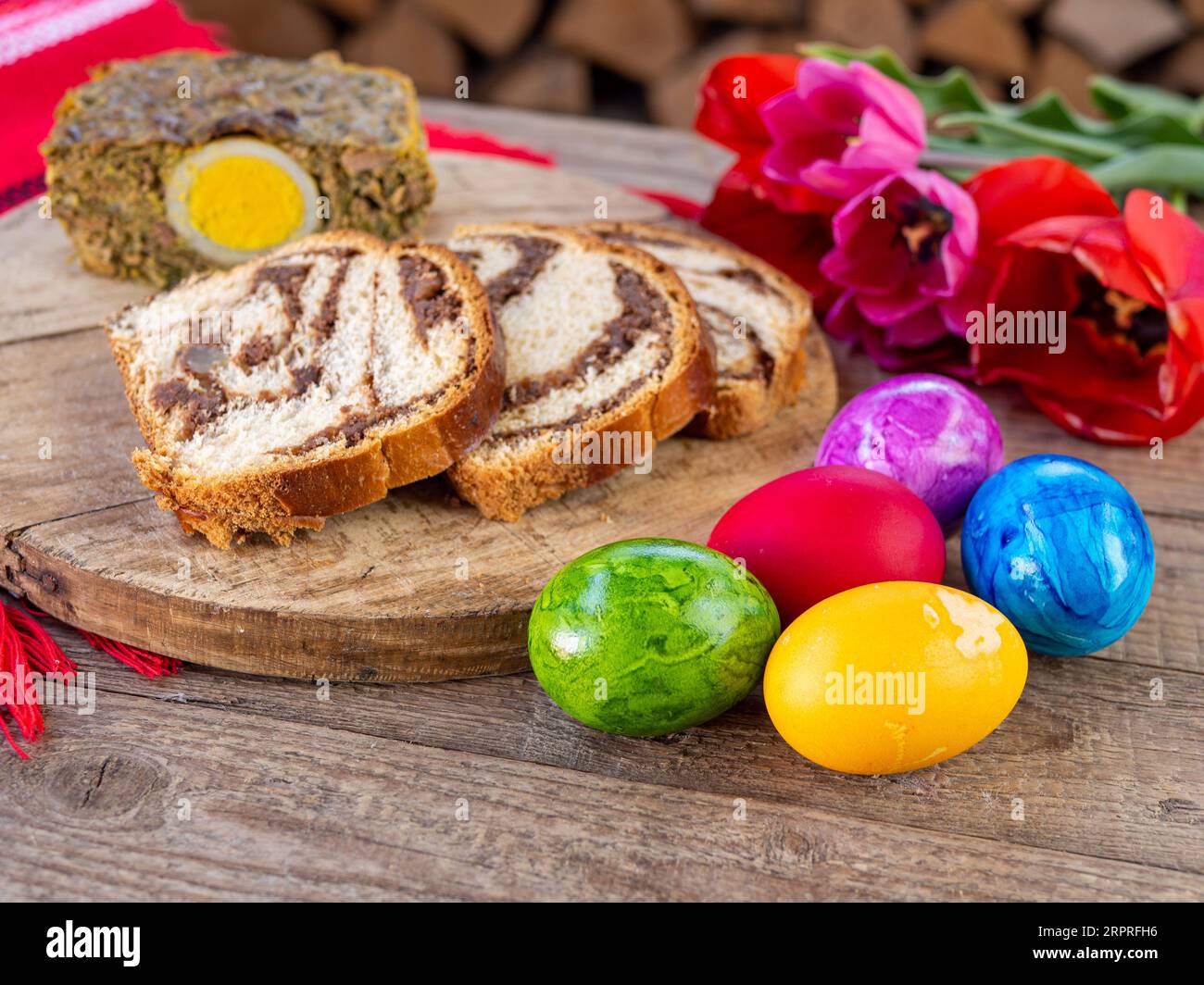 torta di carne di agnello trippa, pan di spagna e uova di pasqua colorate sul tavolo Foto Stock