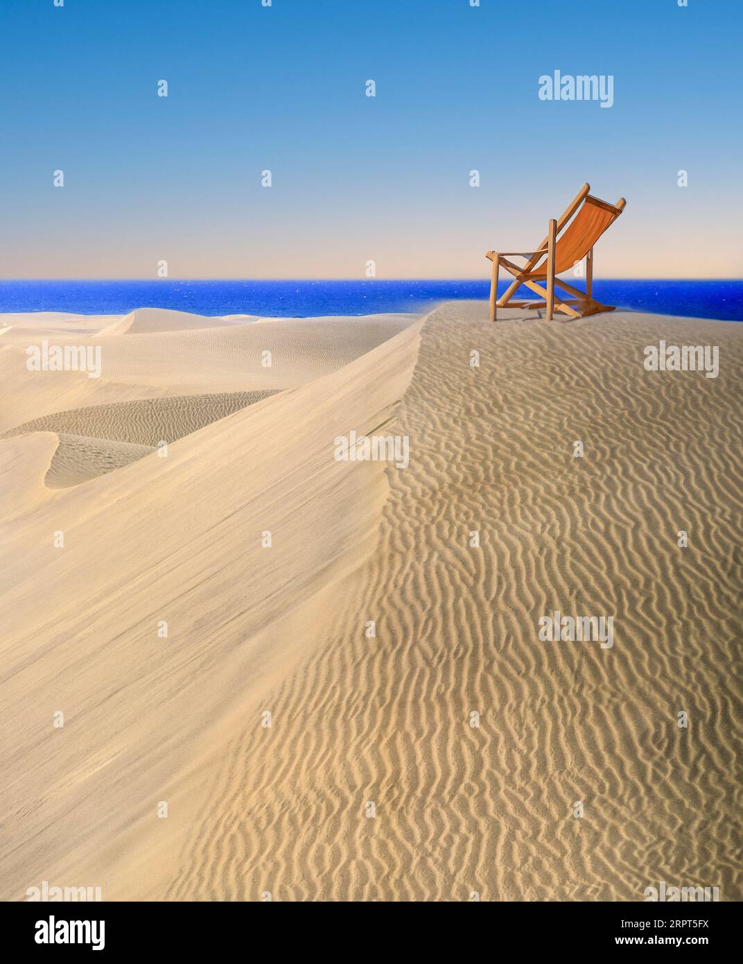 Vacanze "lontano da tutto". Sedia a sdraio su una duna di sabbia deserta che si affaccia sulla vista del cielo di sabbia e del mare. Destinazione esclusiva di viaggio concettuale. Foto Stock