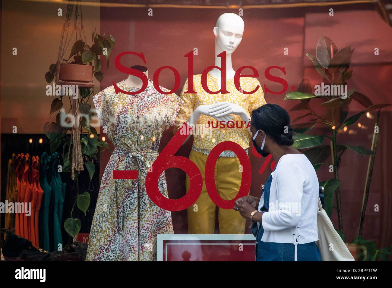 200716 -- PARIGI, 16 luglio 2020 Xinhua -- Una donna che indossa una maschera cammina davanti a un cartello di sconto il primo giorno di vendite estive a Parigi, in Francia, 15 luglio 2020. Le vendite estive della Francia 2020 sono state lanciate mercoledì e termineranno l'11 agosto. Inizialmente era previsto che iniziassero il 24 giugno, ma sono stati rinviati a causa dell'epidemia di COVID-19. Foto di Aurelien Morissard/Xinhua FRANCE-PARIS-COVID-19-SUMMER SALE PUBLICATIONxNOTxINxCHN Foto Stock